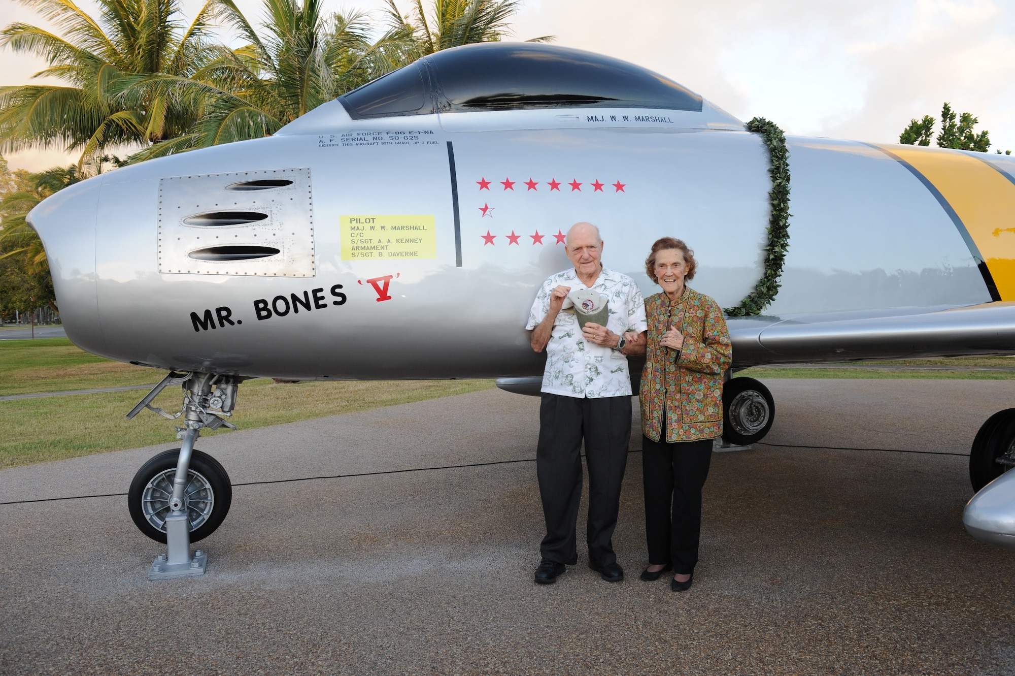 Retired U.S. Air Force Lt. Gen. Winton W. “Bones” Marshall, a combat commander, Korean War ace and former PACAF vice commander, and wife, Millie, who served in WWII as one of the original Women Airforce Service Pilots, pose for a photo in front of the newly repainted static F-86E Sabre fighter aircraft at Joint Base Pearl Harbor-Hickam, Hawaii, Dec. 8, 2011. The Pacific Air Forces and 15th Wing leadership dedicated the aircraft to Marshall in recognition of his sacrifice and service during the Korean War. He is credited with 6 1/2 enemy aircraft destroyed, seven probable aircraft destroyed and six aircraft damaged. (U.S. Air Force photo/Staff Sgt. Gustavo Gonzalez/Released)