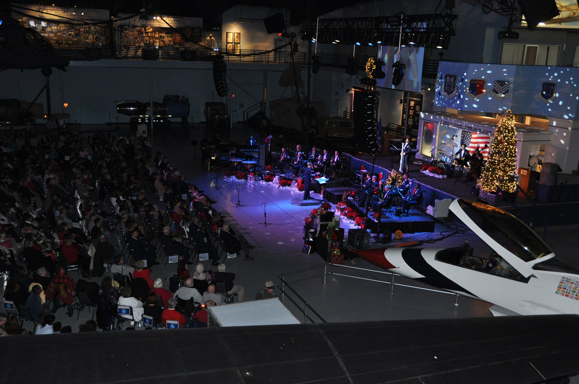 The Band of the U.S. Air Force Reserve performs to a standing room only crowd during the annual Holiday Concert at the Museum of Aviation Dec. 8.  The hour-long show featured traditional holiday songs, as well as special renditions of Christmas favorites like "Little Drummer Boy." (U.S. Air Force photo/Philip Rhodes)