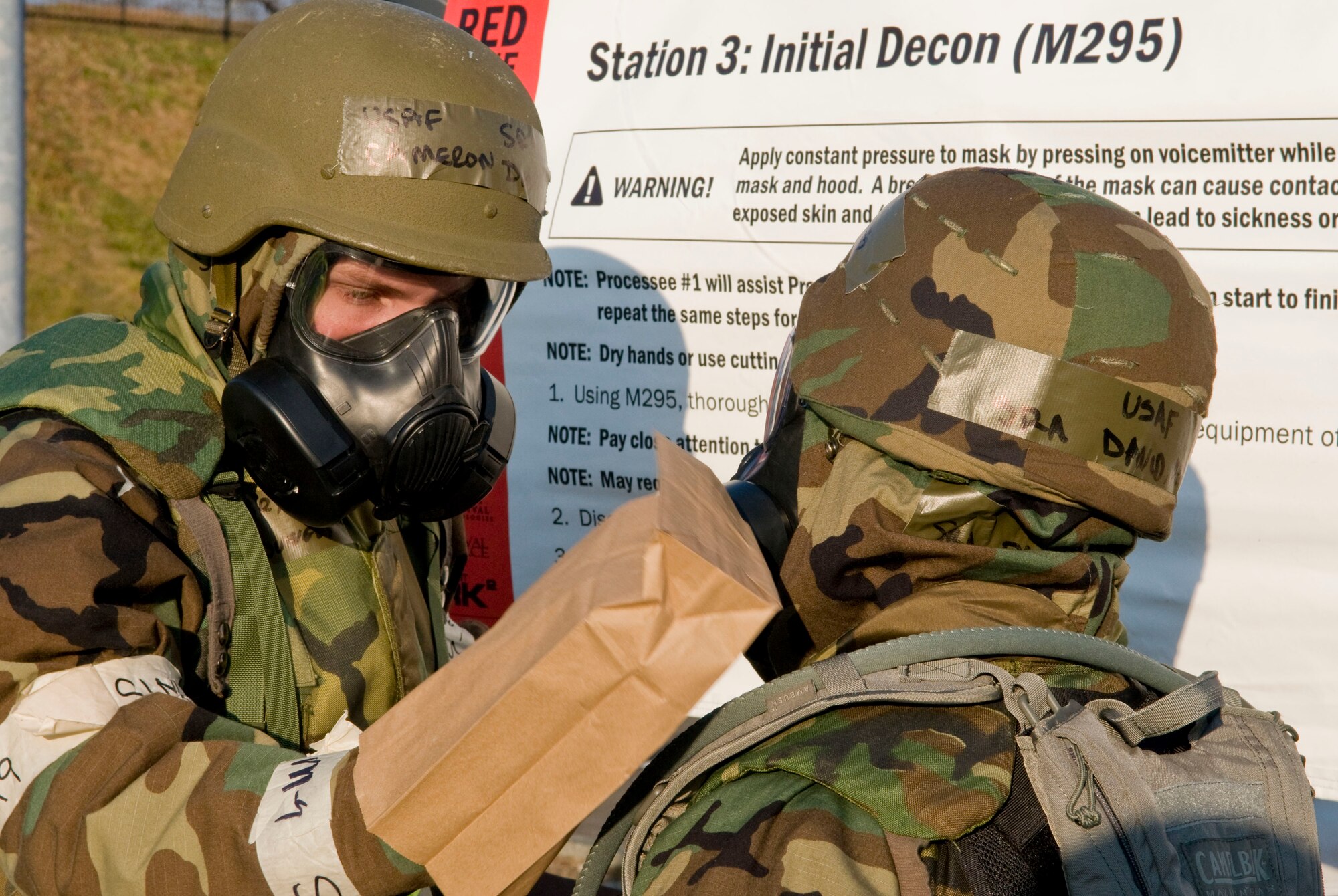 MISAWA AIR BASE, Japan -- Senior Airman Cameron Dungey, 35th Dental Squadron, simulates decontaminating Senior Airman David Adola, 452nd Air Mobility Wing, March Air Reserve Base, Calif., during an operational readiness inspection here Dec. 8. Pacific Air Forces Inspector General is inspecting the wing to test their abilities to deploy and to survive and operate in the deployed environment. (U.S. Air Force photo/Senior Airman Jess Lockoski) 