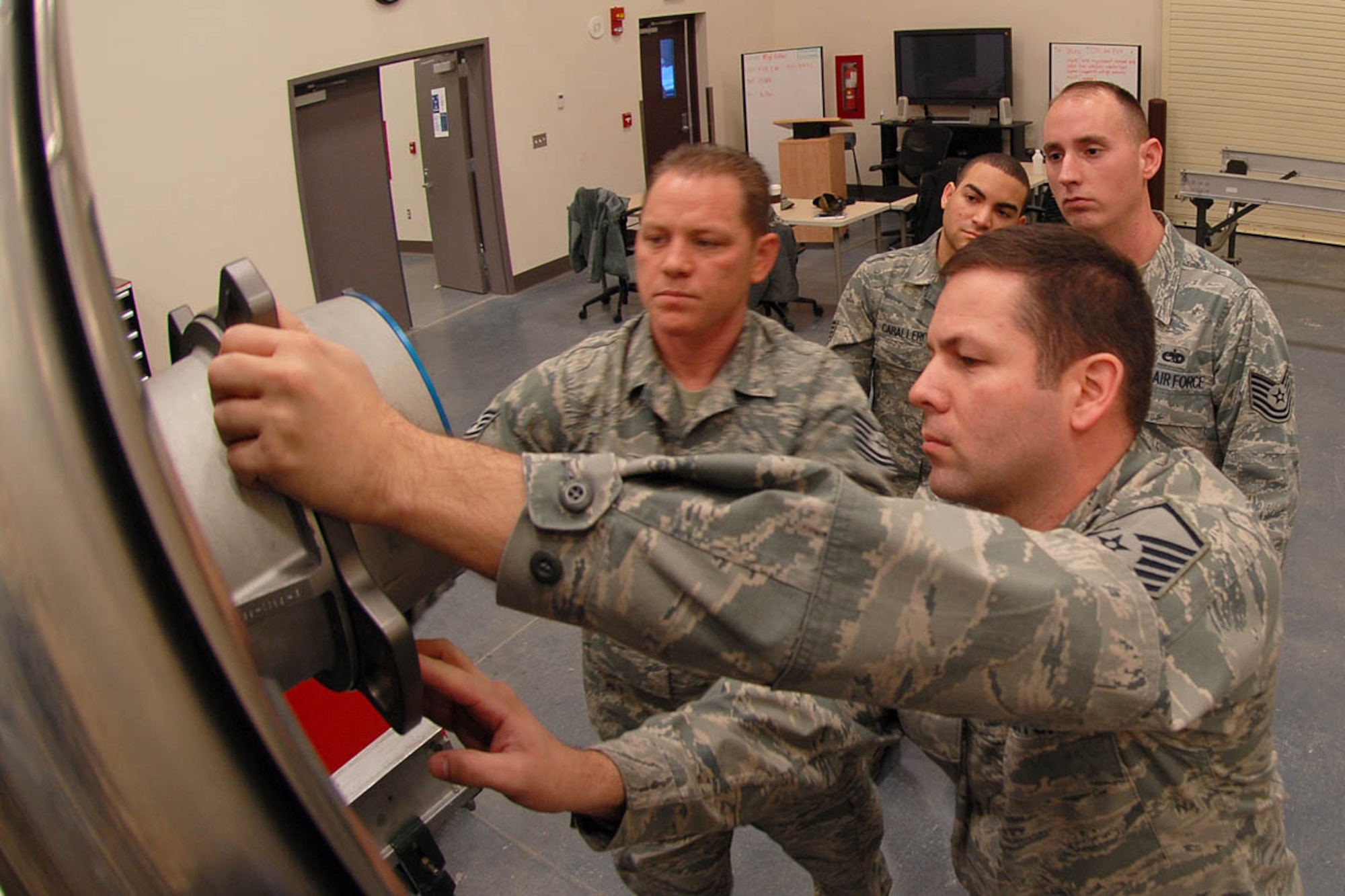 Tech. Sgt. Dan Oden and Master Sgt. Don Arthur show students Air Force Staff Sgt Jose Caballero and Tech.Sgt. Daniel Powers, both assigned to the 3rd Maintenance Squadron, the proper steps for serviceing a Pratt and Whitney F-119-100 engine for a F-22. Oden and Artur are instructors with the 372nd Training Squadron/Detachment 14 on Joint Base Elomendorf-Richardson. The course, F-119 engine intermediate training course consists of 173 hours of classroom instruction and hands on training for students.