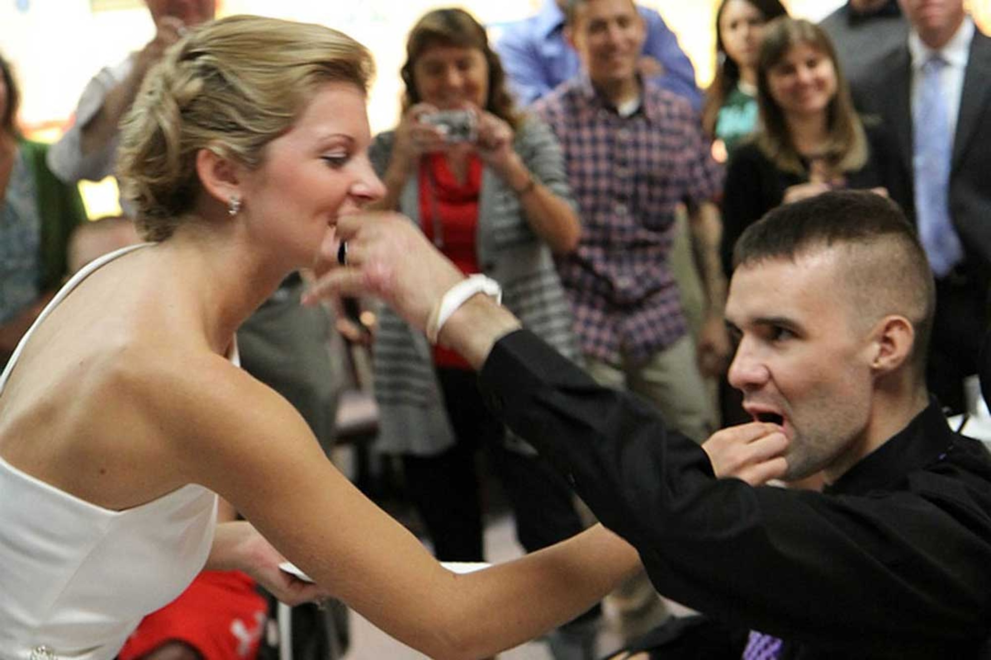 Dana and Sgt. Davin Dumar share in a bite of their wedding cake during Oct. 8 nuptials at Walter Reed Army Medical Center. (Courtesy photo)