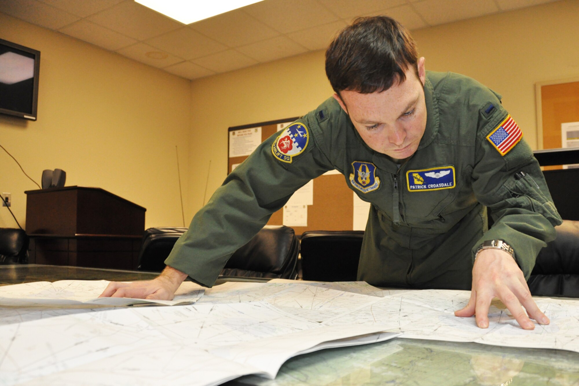 First Lieutenant Patrick Croasdale, C-130 pilot, 700th Airlift Squadron, plots drop zones and prepares to participate in the 14th Annual Randy Oler Memorial Operation Toy Drop, taking place just outside of Fort Bragg, N.C. Dec 10. This is the second year that Dobbins ARB is participating in the toy drop. Approximately 1600 paratroopers from the U.S. Army Civil Affairs and Psychological Operations Command, 18th Airborne Corps and visiting paratroopers from across the nation will parachute from Dobbins’ C-130 aircraft and deliver new, unwrapped toys to be distributed to local children's homes and social service agencies. “This is the second year that Dobbins has had the opportunity to participate in the toy drop,” said Croasdale. (U.S. Air Force photo/Senior Airman Christina Bozeman)