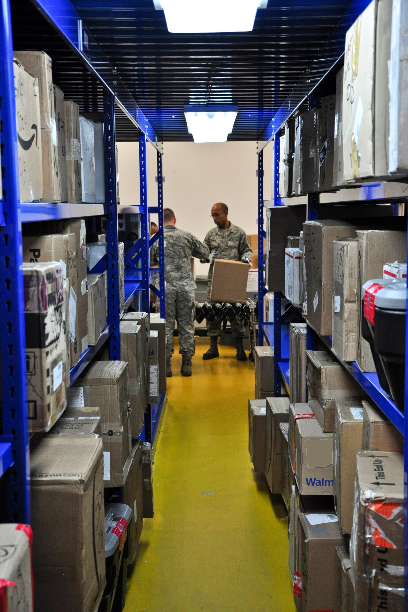 Staff Sgt. Ryan Bonner, a postal clerk with the 51st Communications Squadron, processes and sorts some packages here Dec. 6, 2011. The Military Postal Service Agency here processes about 3,000 pieces of mail a day during the holiday season, and there is a lot that goes into “pitching” mail. (U.S. Air Force photo/Tech. Sgt. Chad Thompson)