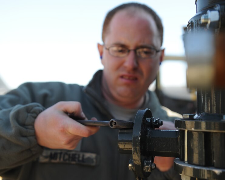 Senior Airman Joel Mitchell, 2nd Logistics Readiness Squadron refueling maintainer, tightens a bolt on an R-12 fuel truck on Barksdale Air Force Base, La., Dec. 7. The Airmen from the 2 LRS petroleum, oil and lubrication flight were called out to refuel a B-52H Stratofortress with Jet Propulsion 8. JP-8 was formulated to contain less carcinogens and neurotoxins than its predecessor JP- 4. (U.S. Air Force photo/Airman 1st Class Micaiah Anthony)(RELEASED)