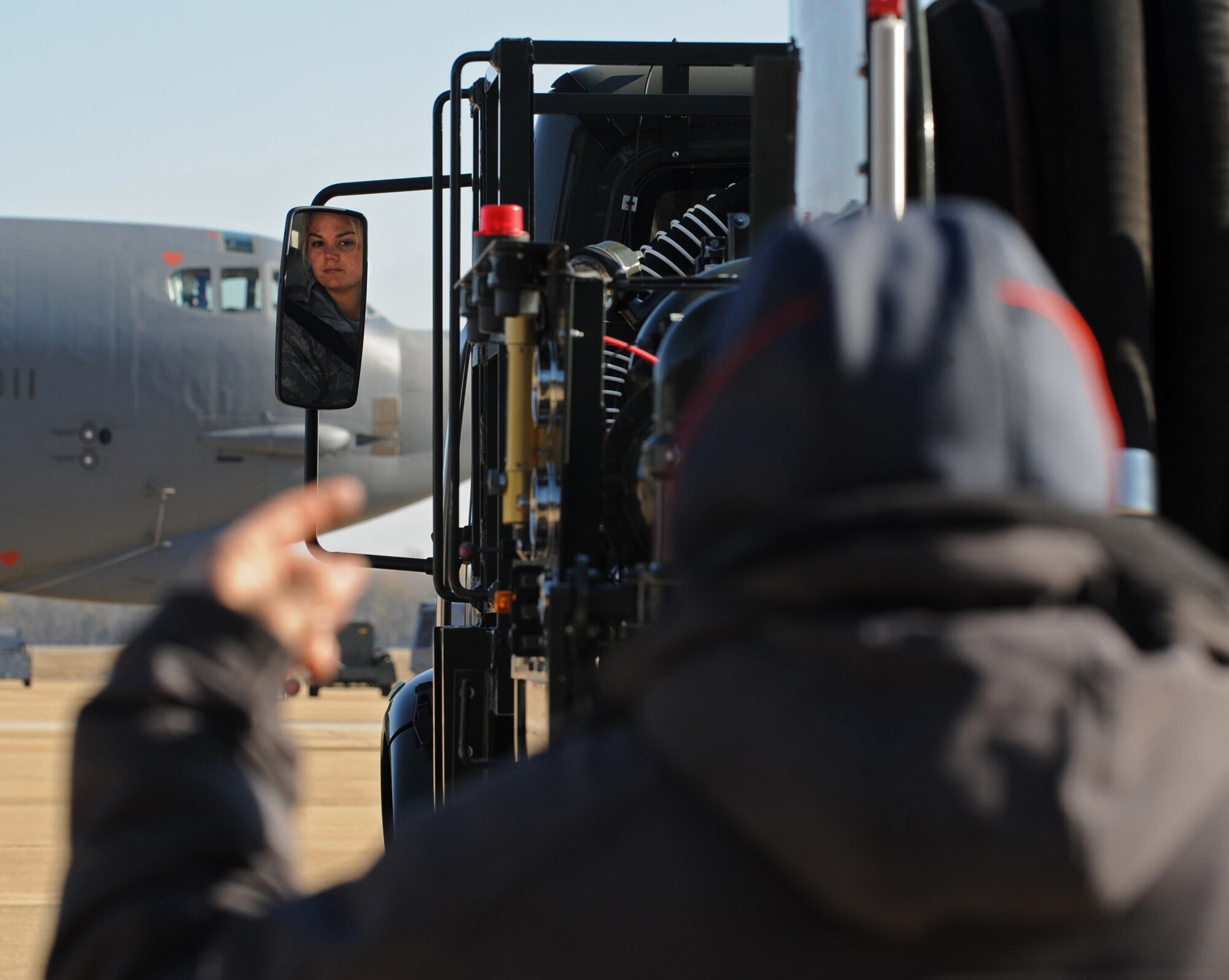 Tech. Sgt. David Johnson, 307th Aircraft Maintenance Squadron dedicated crew chief, signals Airman 1st Class Rachel Rodgers, 2nd Logistics Readiness Squadron fuel distribution operator, to back up an R-11 fuel truck on Barksdale Air Force Base, La., Dec. 7. The 2 LRS petroleum, oil and lubrication flight manages and distributes fuel for all aircraft and government vehicles on base.  (U.S. Air Force photo/Airman 1st Class Micaiah Anthony)(RELEASED)