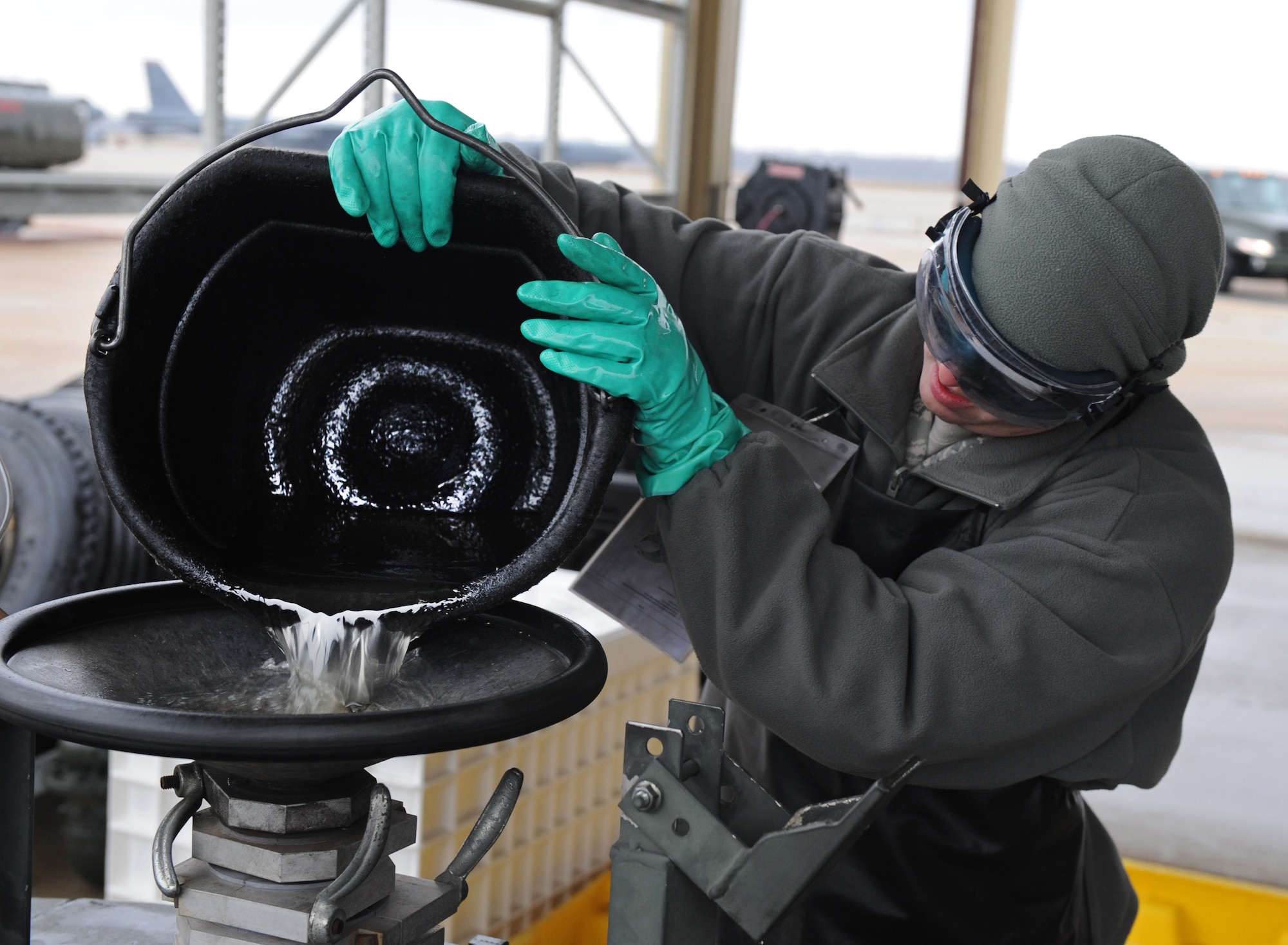Senior Airman Joel Mitchell, 2nd Logistics Readiness Squadron refueling maintainer, pours fuel into a reclaiming tank on Barksdale Air Force Base, La., Dec. 6. Reclaimed fuel is inspected for contamination. If no contamination is present the fuel is returned to one of the main tanks for later use. (U.S. Air Force photo/Airman 1st Class Micaiah Anthony)(RELEASED)   