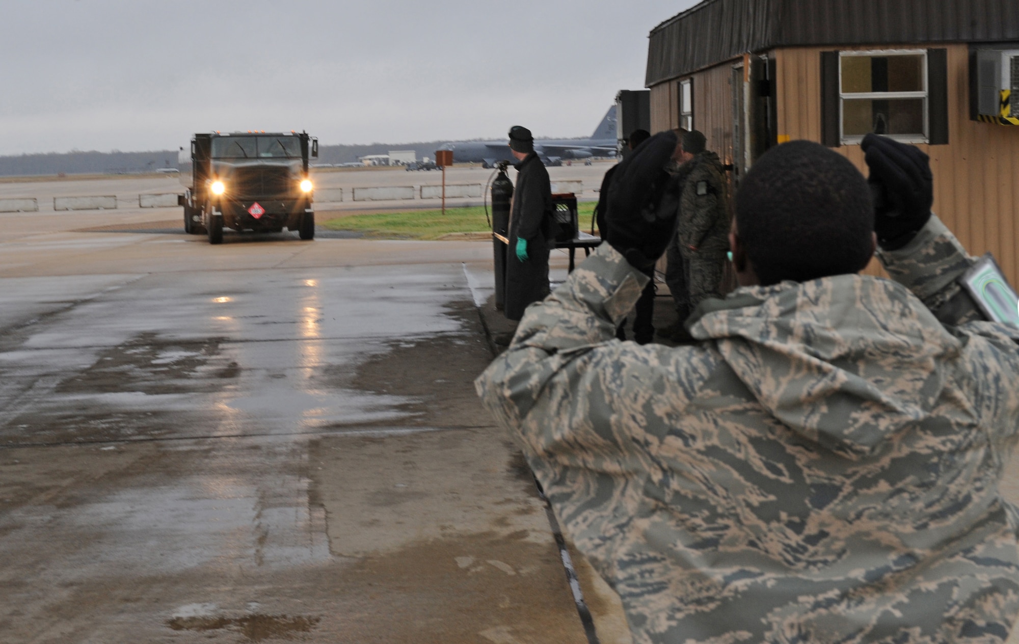 Airman Gregory Parish, 2nd Logistics Readiness Squadron fuels apprentice, guides Senior Airman Gregory Presley, 2 LRS fuels distributor, into the inspection area on Barksdale Air Force Base, La., Dec. 6. Inspections are conducted daily to ensure all fuel trucks are ready and safe to use. (U.S. Air Force photo/Airman 1st Class Micaiah Anthony)(RELEASED)