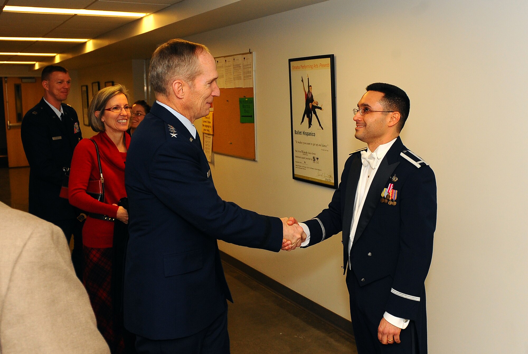 U.S. Air Force Gen. Mike Hostage, commander of Air Combat Command, greets 1st Lt. Rafael F. Toro-Quinones, commander, USAF Heartland of America Band following his first holiday concert with the band, Omaha, Neb., Dec. 7.  The "Silver and Gold" concert marked a quarter century of the bands holiday concerts around Omaha.  (U.S. Air Force Photo by Josh Plueger/Released)