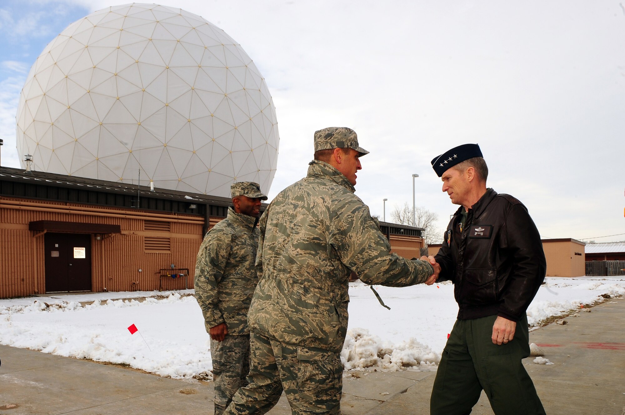 U.S. Air Force Col. Donovan Routsis, 55th Communications Group commander, welcomes Gen. Mike Hostage, commander of Air Combat Command, to the 55th Strategic Communications Squadron?s Command and control systems flight as part of a two-day tour of Offutt Air Force Base, Neb., Dec. 7.  The C2 Systems Flight works with the defense satellite communications systems to provide secure command and control, voice, and data hotline capabilities to customers worldwide, to include the president of the United States, secretary of defense, U.S. Strategic Command, joint chiefs of staff, Air Combat Command and more.  (U.S. Air Force Photo by Josh Plueger/Released)