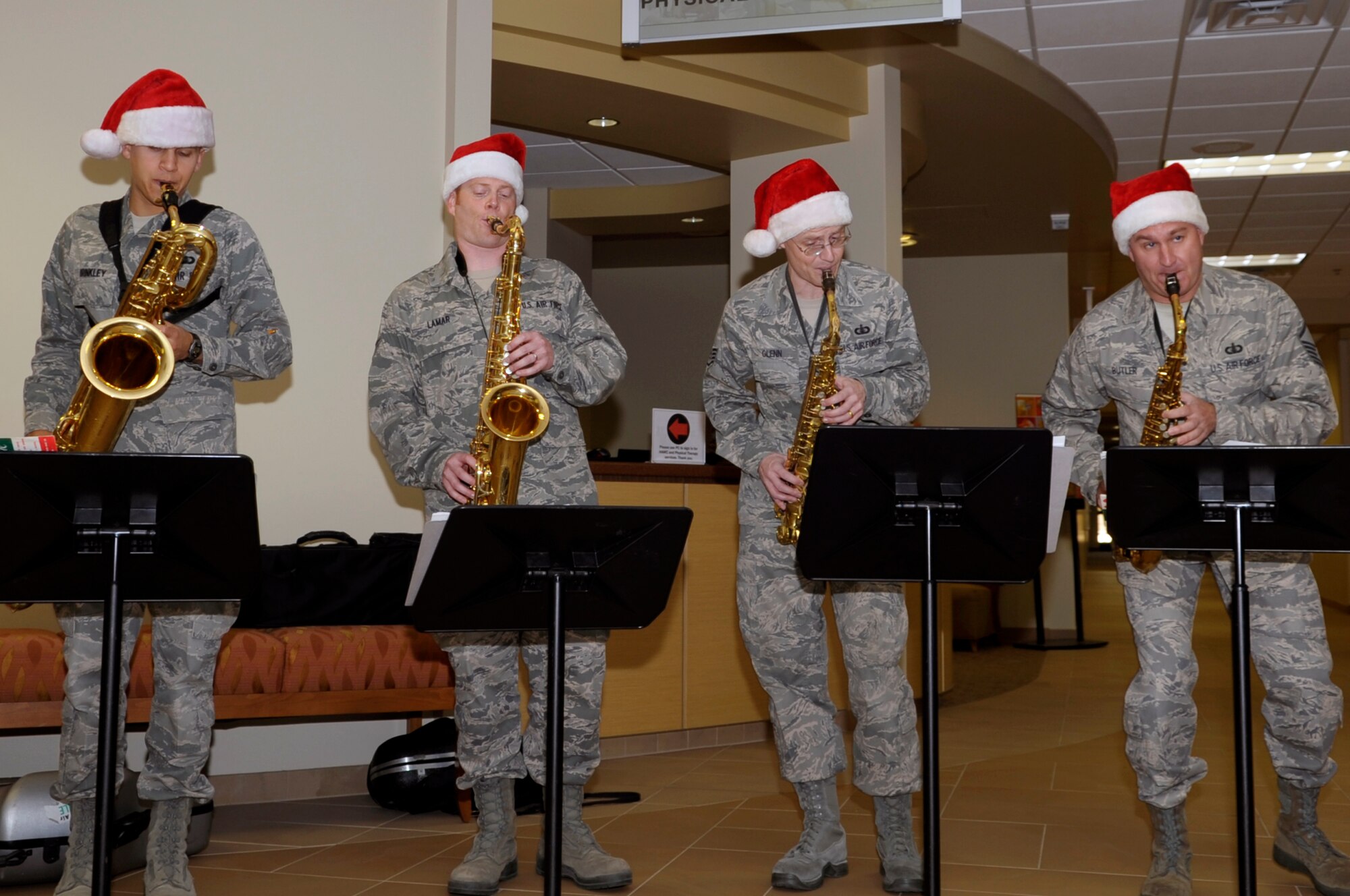 VANDENBERG AIR FORCE BASE, Calif. -- Master Sgt. James Butler, Staff Sgt. Ron Glenn, Airman 1st Class Issac Lamar and Airman 1st Class Caleb Brinkley from the Band of the Golden West, Travis AFB, Calif., perform Christmas carols in the 30th Medical Group foyer here Thursday, Dec. 8, 2011. The saxophone quartet toured main base and played Christmas songs to members of Vandenberg. (U.S. Air Force photo/Jerry E. Clemens Jr.)