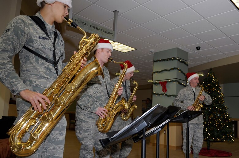 VANDENBERG AIR FORCE BASE, Calif. -- Master Sgt. James Butler, Staff Sgt. Ron Glenn, Airman 1st Class Issac Lamar and Airman 1st Class Caleb Brinkley from the Band of the Golden West from Travis AFB, Calif., perform Christmas carols in the 30th Medical Group foyer here Thursday, Dec. 8, 2011. The saxophone quartet toured main base and played Christmas songs to members of Vandenberg. (U.S. Air Force photo/Jerry E. Clemens Jr.)