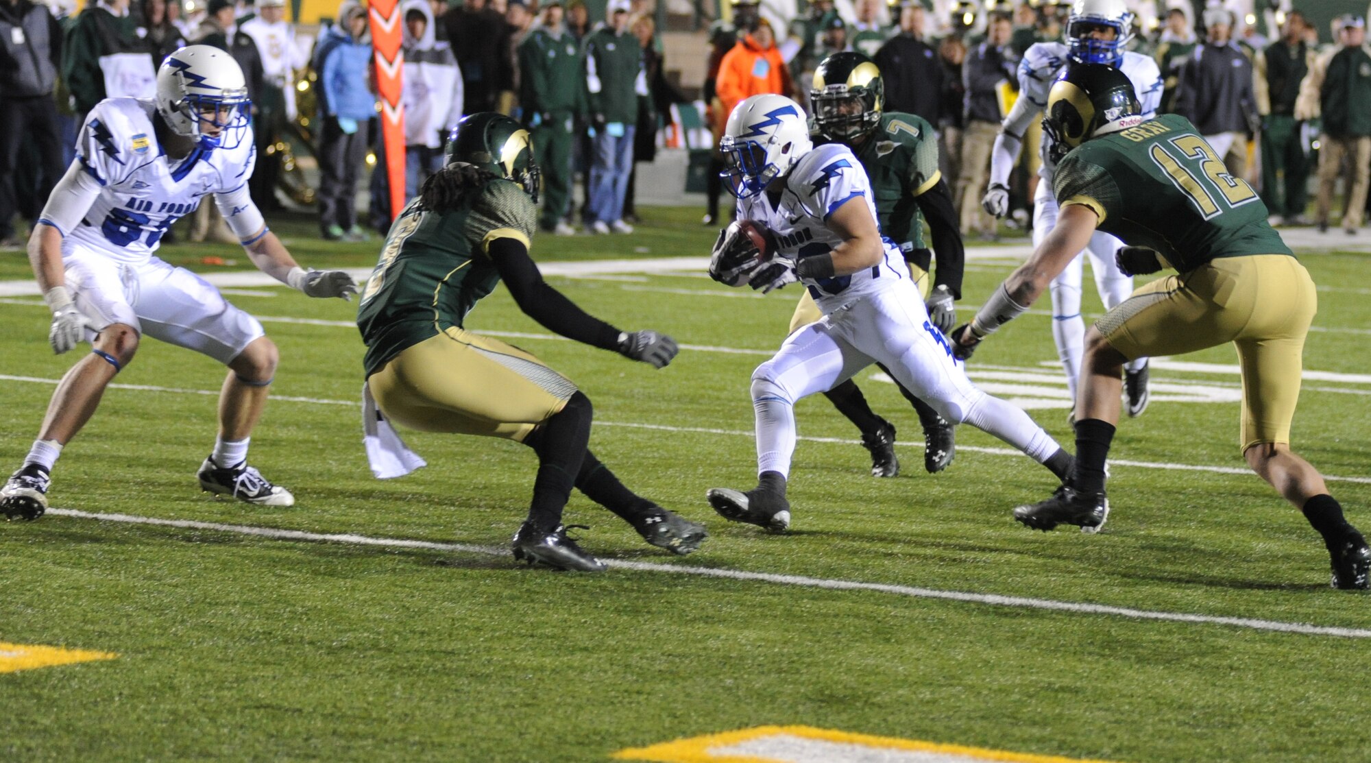 Air Force wide receiver Cody Getz, center, dodges Colorado State defenders en route to his first touchdown of the season during the Falcons' 45-21 victory over the Rams Nov. 26, 2011. Regional rivalries like Air Force-CSU were one of the factors in Air Force's decision to stay in the Mountain West Conference, Academy Superintendent Lt. Gen. Mike Gould said Dec. 7. (U.S. Air Force photo/John Van Winkle)