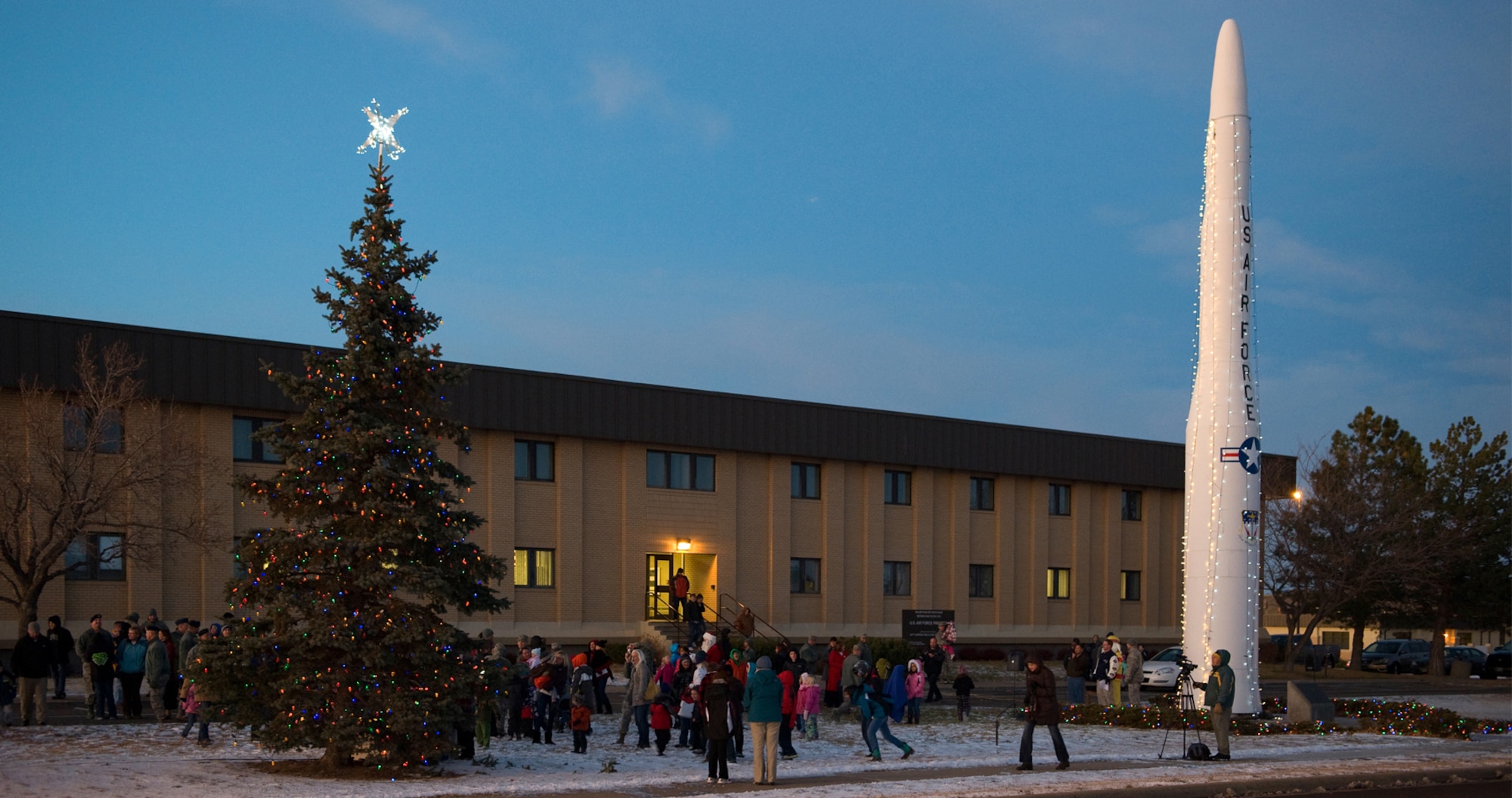 Members of Team Malmstrom watch with anticipation as the lights on a tree and Minuteman I display are lit during the tree lighting ceremony Dec. 1. (U.S. Air Force photo/Beau Wade)