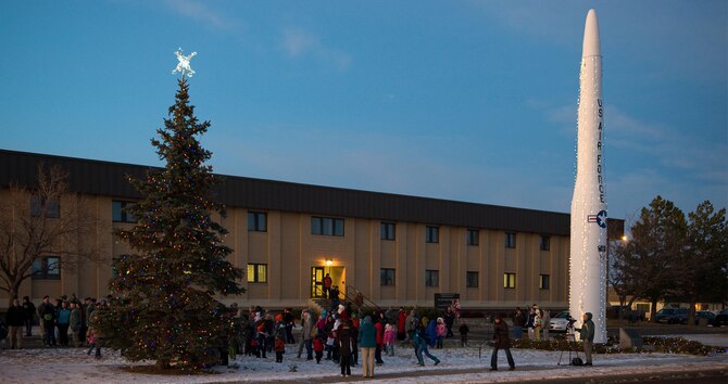 Members of Team Malmstrom watch with anticipation as the lights on a tree and Minuteman I display are lit during the tree lighting ceremony Dec. 1. (U.S. Air Force photo/Beau Wade)
