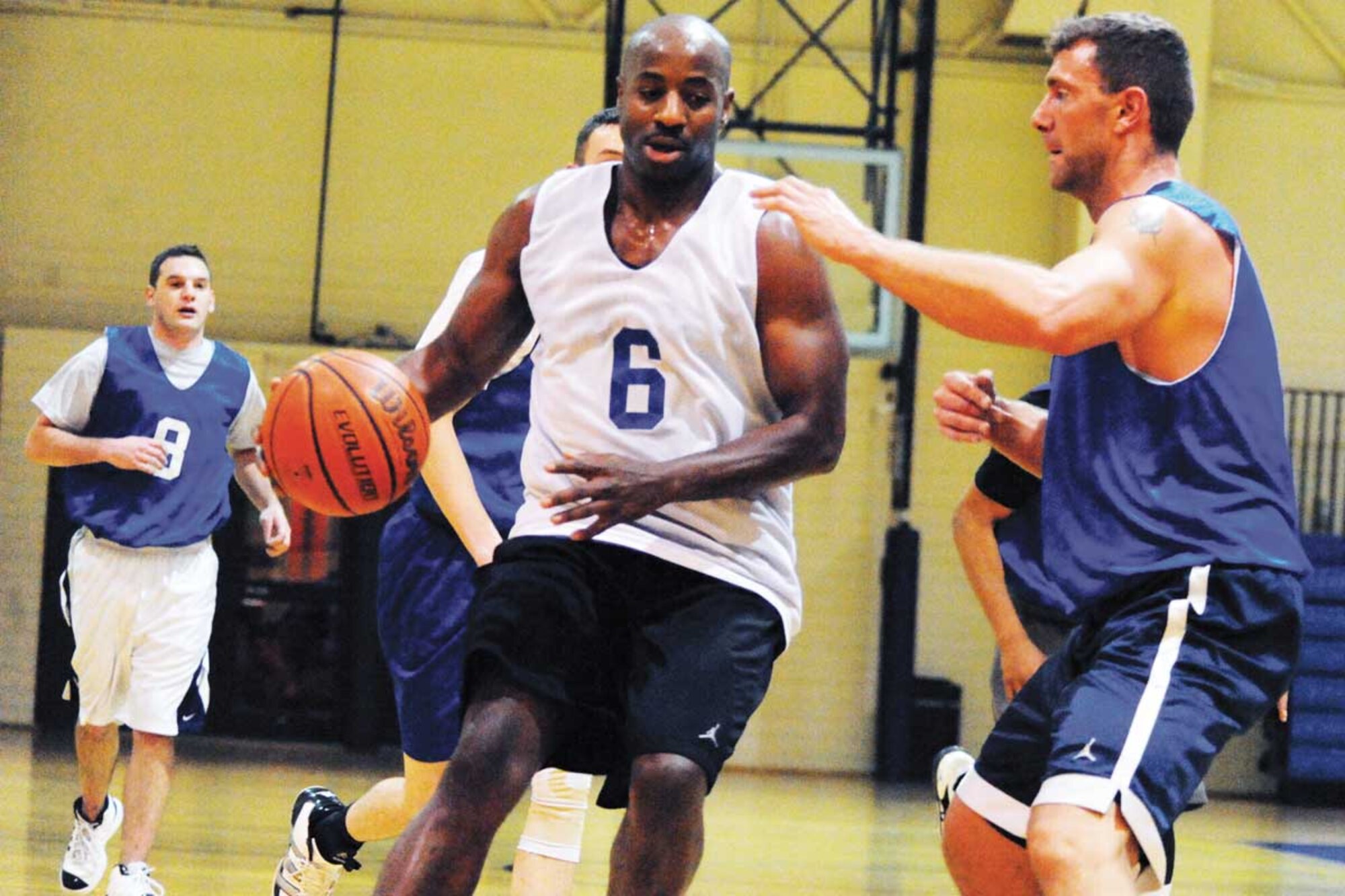 Members of the intramural basketball teams from the 673d Civil Engineering Squadron and the 673d Contracting Squadron compete at the Elmendorf Fitness Center Nov. 30. Intramural sports are one way to stay fit in the winter at Joint Base Elmendorf-Richardson. (U.S. Air Force photo/Senior Airman Blake Mize)