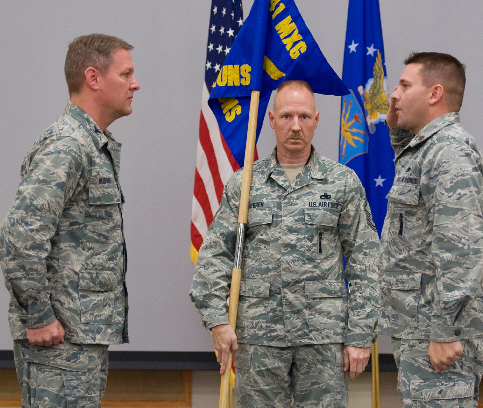Maj. Thomas Thorp renders a salute to Col. David Bliesner after accepting command of the newly assigned 341st Munitions Squadron Dec. 1 while Chief Master Sgt. William Nygren looks on. Thorp is commander and Nygren superintendent of the 341st MUNS, which now is officially part of the 341st Maintenance Group, which Bliesner commands. (U.S. Air Force photo/Beau Wade)