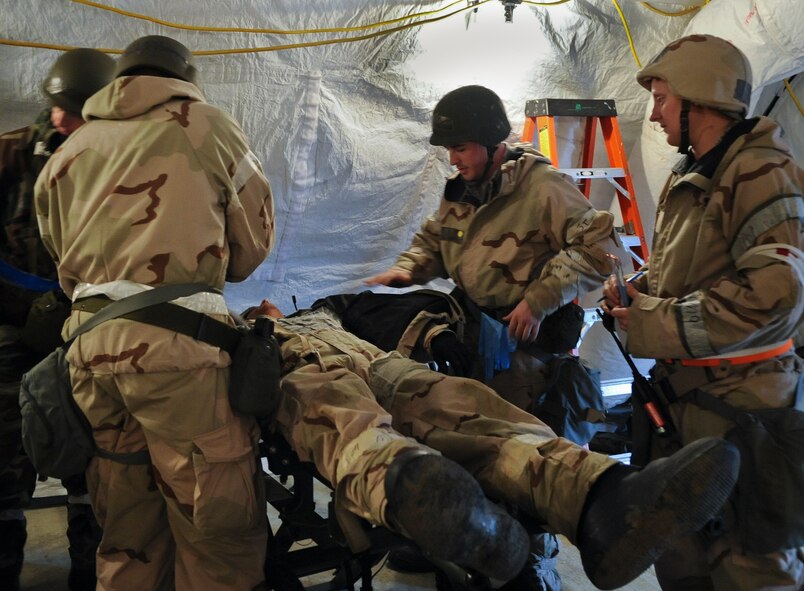U.S. Airmen from the 23rd Medical Group provide assistance to an injured victim during a phase II operational readiness exercise at Moody Air Force Base, Ga., Dec. 7, 2011. Throughout the ORE, members practiced their skills to prepare for real-world occurrences. (U.S. Air Force photo by Airman 1st Class Olivia Dominique/Released)