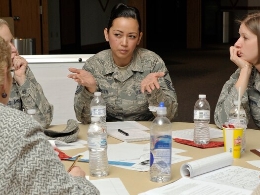 Master Sgt. Tiffany Smith, center, shares an idea with others in her roundtable discussion during an Air Force Academy women's mentoring initiative meeting at the Academy's Milazzo Center Nov. 30, 2011. Smith is superintendent of the Manpower and Personnel Directorate's Command Personnel Division. (U.S. Air Force photo/Elizabeth Andrews)