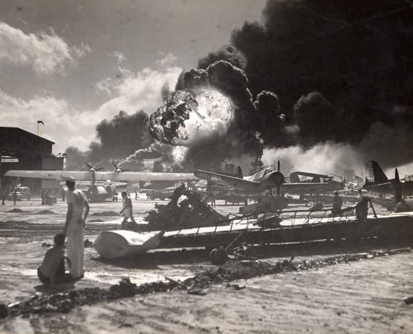 Airmen, Sailors and Marines scramble to get U.S. aircraft in the air or out of harm’s way as they come under attack on Dec. 7, 1941. U.S. service members fulfilled their military missions while protecting their comrades-at-arms in the face of a surprise assault by an overwhelming enemy airpower, continuing a legacy of service that inspires new generations of military. (Courtesy Photo/National Archives and Records Administration)