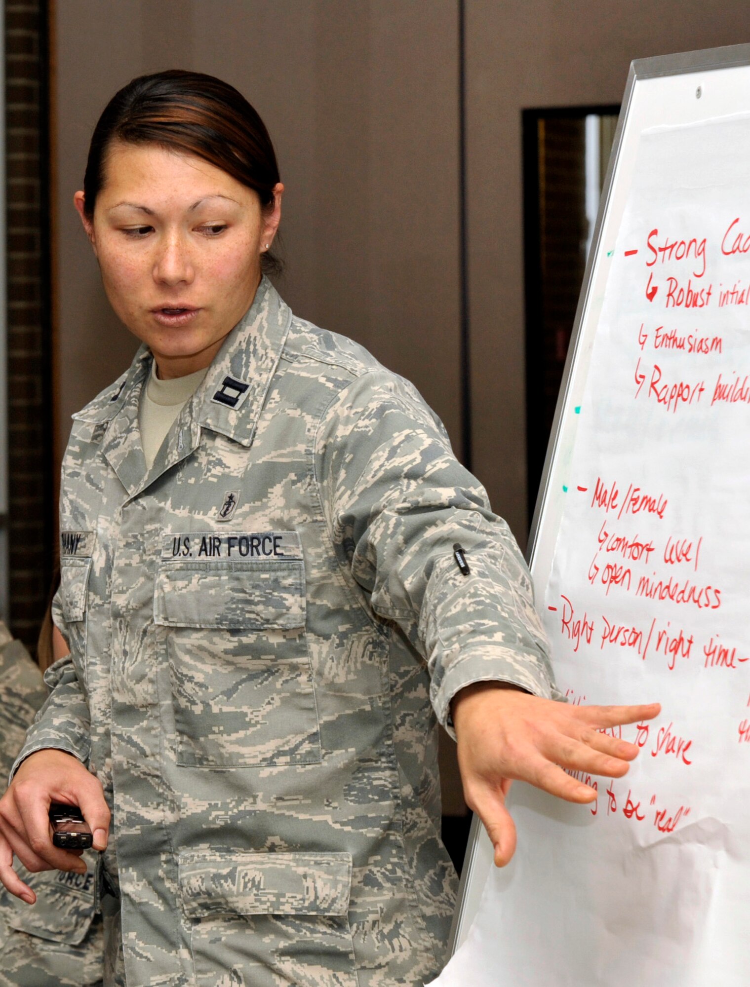 Capt. Carla Stephany shares her table's ideas with the larger group during the Air Force Academy's women's mentoring initiative at the Milazzo Center Nov. 30, 2011. The purpose of the meeting was to set up a vision for implementing and assessing a women's mentoring program at the Academy. Stephany is a clinical social worker at the Academy's Peak Performance Center. (U.S. Air Force photo/Elizabeth Andrews)