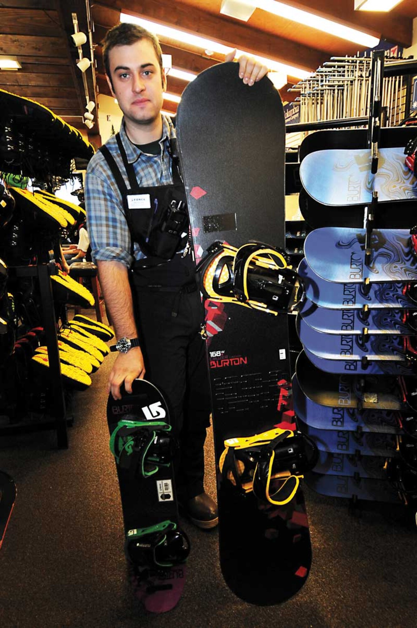 Trevor Bird, Hillberg Ski Area manager, shows off the smallest and largest snowboards Hillberg now has available this year as part of the new Burton collection Saturday. JBER is the first military base to have the Burton Learn-to-Ride system.  (U.S. Air Force photo/Staff Sgt. Cynthia Spalding)