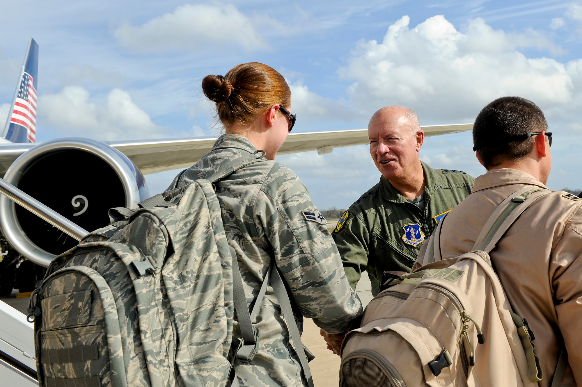 JSTARS crewmembers are welcomed home by Lt. Gen. Harry Wyatt III, Air National Guard director, center, as they step off a jet after a four-month deployment in Southeast Asia, Robins Air Force Base, Ga., Dec. 05, 2011.  Wyatt had just finished an orientation flight aboard the E-8 Joint STARS aircraft and landed in time to greet the deployers.  (National Guard photo by Master Sgt. Roger Parsons/Released)