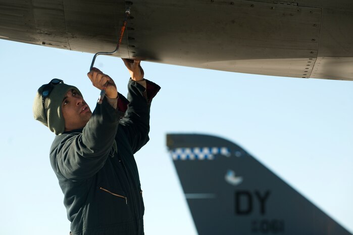 U.S. Air Force Staff Sgt. Trevor Helm, 7th Aircraft Maintenance Squadron crew chief, Dyess Air Force Base, Texas, performs a pre-flight inspection on a B-1 Lancer, 77th Weapons Squadron, Dyess Air Force Base, Texas, during the U.S. Air Force Weapons School mission employment exercise Dec. 7, 2011, at Nellis Air Force Base, Nev. The two-week-long mission employment phase is the final part of a five-and-a-half-month Weapons School graduate course that showcases the students newly acquired skills to test their ability to plan, execute and lead complex missions. (U.S. Air Force photo by Staff Sgt. Christopher Hubenthal/Released)