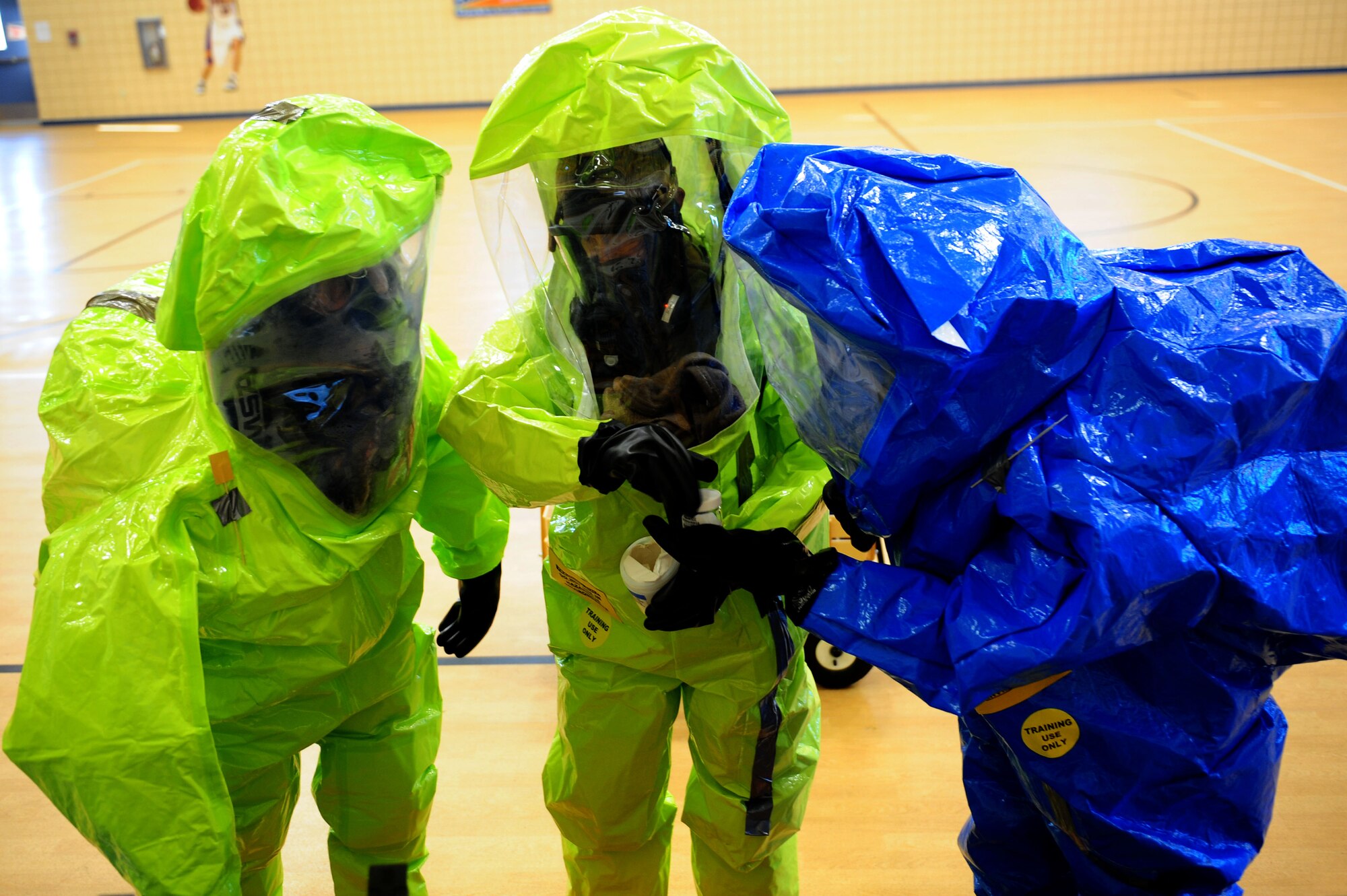 U.S. Air Force Senior Airman Ryan Woody, 633rd Civil Engineer Squadron emergency management flight, Staff Sgt. Kyle Rollins, 633rd CES fire emergency services crew chief, and Tech. Sgt. Michael Woodburn, 633rd CES Bio-environmental flight, prepare to determine an unidentified substance during the HAZMAT portion of an active shooter exercise at Langley Air Force Base, Va., Dec. 8, 2011.  The full-scale exercise prepared 633rd Air Base Wing personnel to respond to chemical, biological, radiological and nuclear situations, and to engage in an active shooter and/or hostage situation. (U.S. Air Force photo by Airman 1st Class Kayla Newman/Released)
