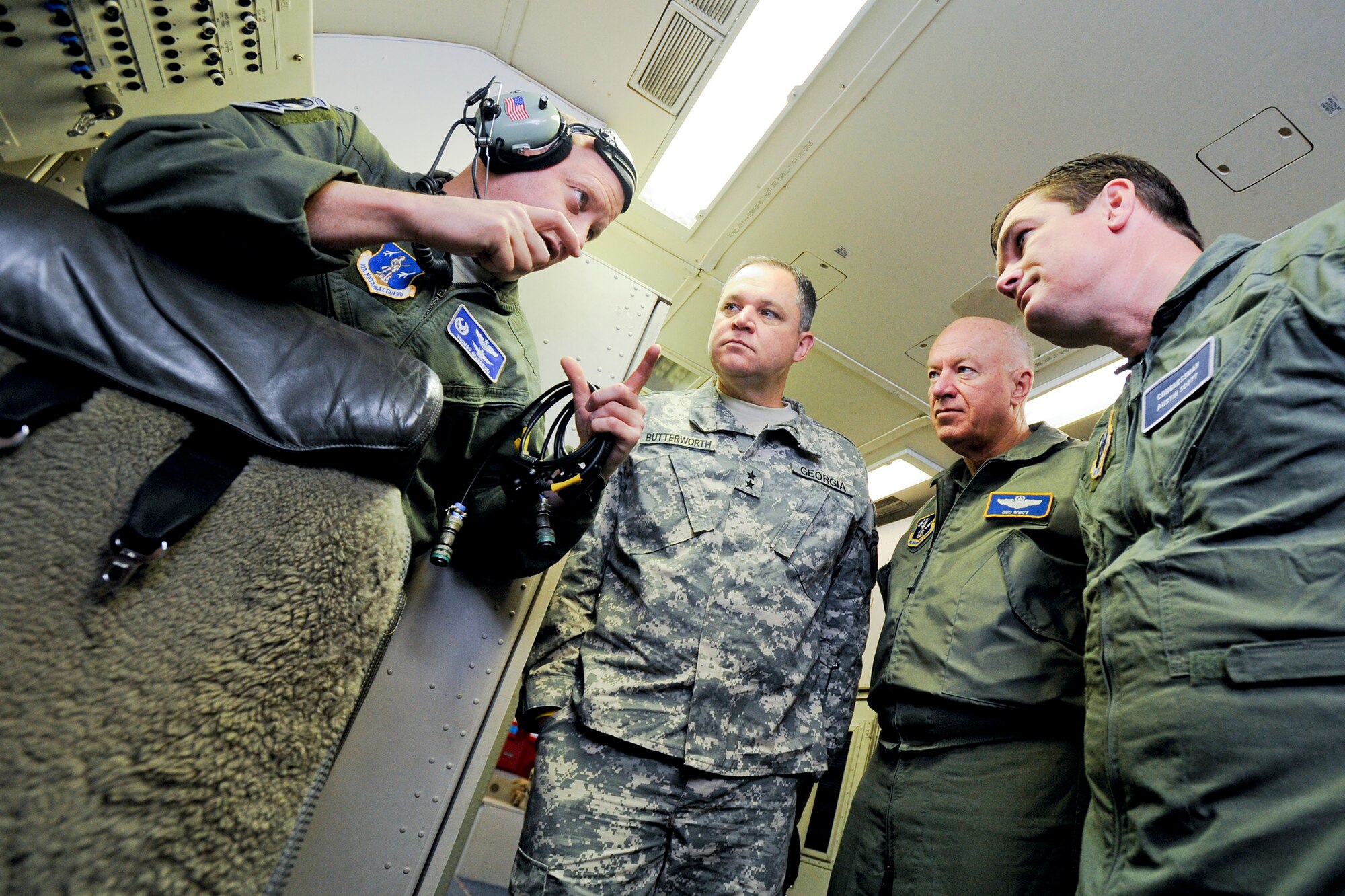 Air National Guard (ANG) Lt. Col. Thomas Grabowski, left, 116th Operations Support Squadron commander, briefs Maj. Gen. Jim Butterworth, Adjutant General of Ga., Lt. Gen. Harry Wyatt III, ANG director, and Congressman Austin Scott, on the mission and capabilities of the E-8 Joint STARS (JSTARS) during an orientation flight aboard the aircraft, Robins Air Force Base, Ga., Dec. 05, 2011.
During the training sortie, JSTARS crew members demonstrated real-world scenarios to show the versatility of the weapon system.  (National Guard photo by Master Sgt. Roger Parsons/Released)

