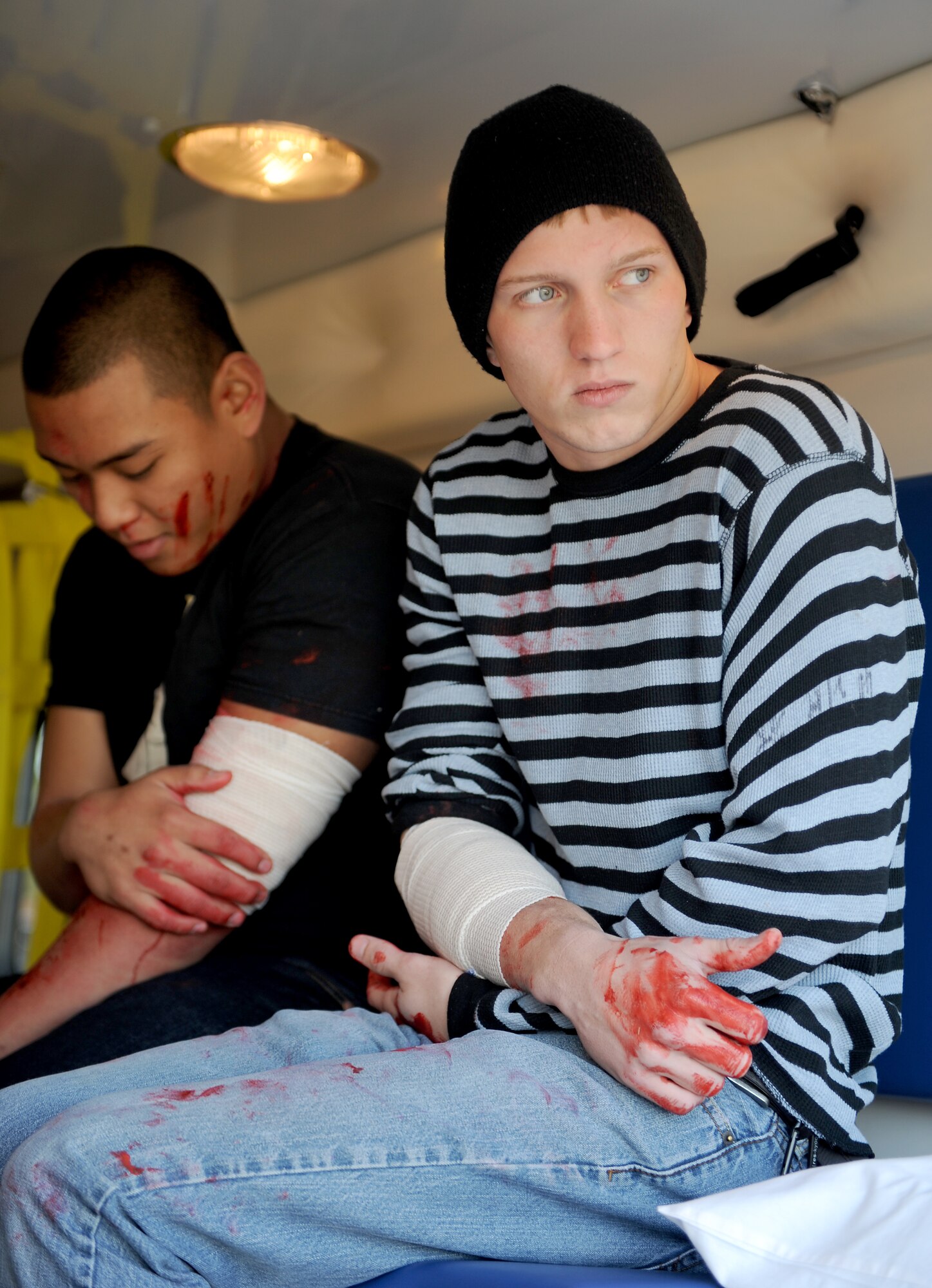 U.S. Air Force Airmen 1st Class Matthew Edquid, 633rd Logistics Readiness Squadron material management apprentice, and Jordan Rushing, a 633rd Civil Engineer Squadron geo-base apprentice, receive medical treatment in an ambulance during an active shooter exercise at Langley Air Force Base, Va., Dec. 8, 2011. The exercise helped to prepare 633rd Air Base Wing personnel for future exercises and potential real-world situations. (U.S. Air Force photo by Staff Sgt. Antoinette Gibson/Released)