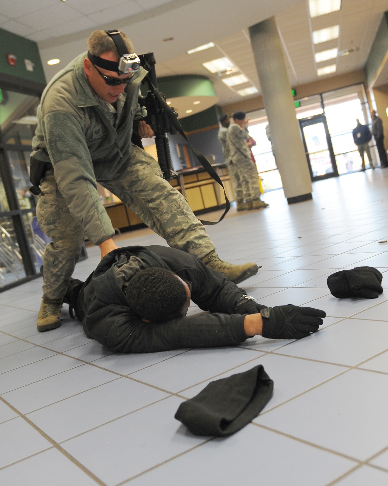 U.S. Air Force Tech. Sgt. James Gardner, 633rd Security Forces Squadron flight chief, apprehends a gunman during an active shooter exercise at Langley Air Force Base, Va., Dec. 8, 2011. The exercise helped to prepare 633rd Air Base Wing personnel for future exercises and potential real-world situations. (U.S. Air Force photo by Staff Sgt. Antoinette Gibson)

