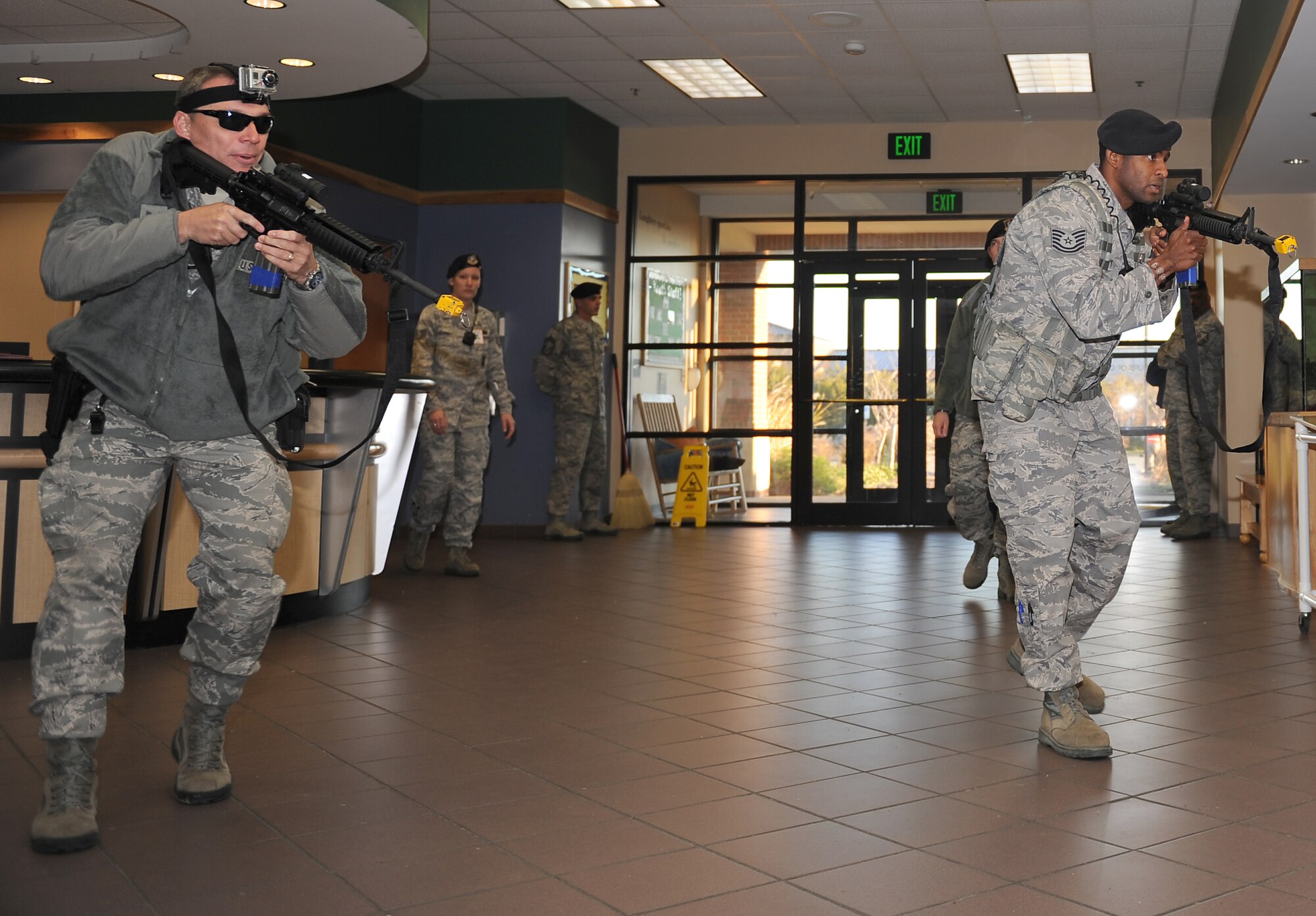 U.S. Air Force Tech. Sgts. James Gardner and Justo Scott, 633rd Security Forces Squadron flight chiefs, conduct a building sweep of the Youth Center during an active shooter exercise at Langley Air Force Base, Va., Dec. 8, 2011. The exercise helped to prepare 633rd Air Base Wing personnel for future exercises and real-world situations. (U.S. Air Force photo by Staff Sgt. Antoinette Gibson/Released)
