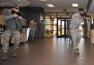 U.S. Air Force Tech. Sgts. James Gardner and Justo Scott, 633rd Security Forces Squadron flight chiefs, conduct a building sweep of the Youth Center during an active shooter exercise at Langley Air Force Base, Va., Dec. 8, 2011. The exercise helped to prepare 633rd Air Base Wing personnel for future exercises and real-world situations. (U.S. Air Force photo by Staff Sgt. Antoinette Gibson/Released)