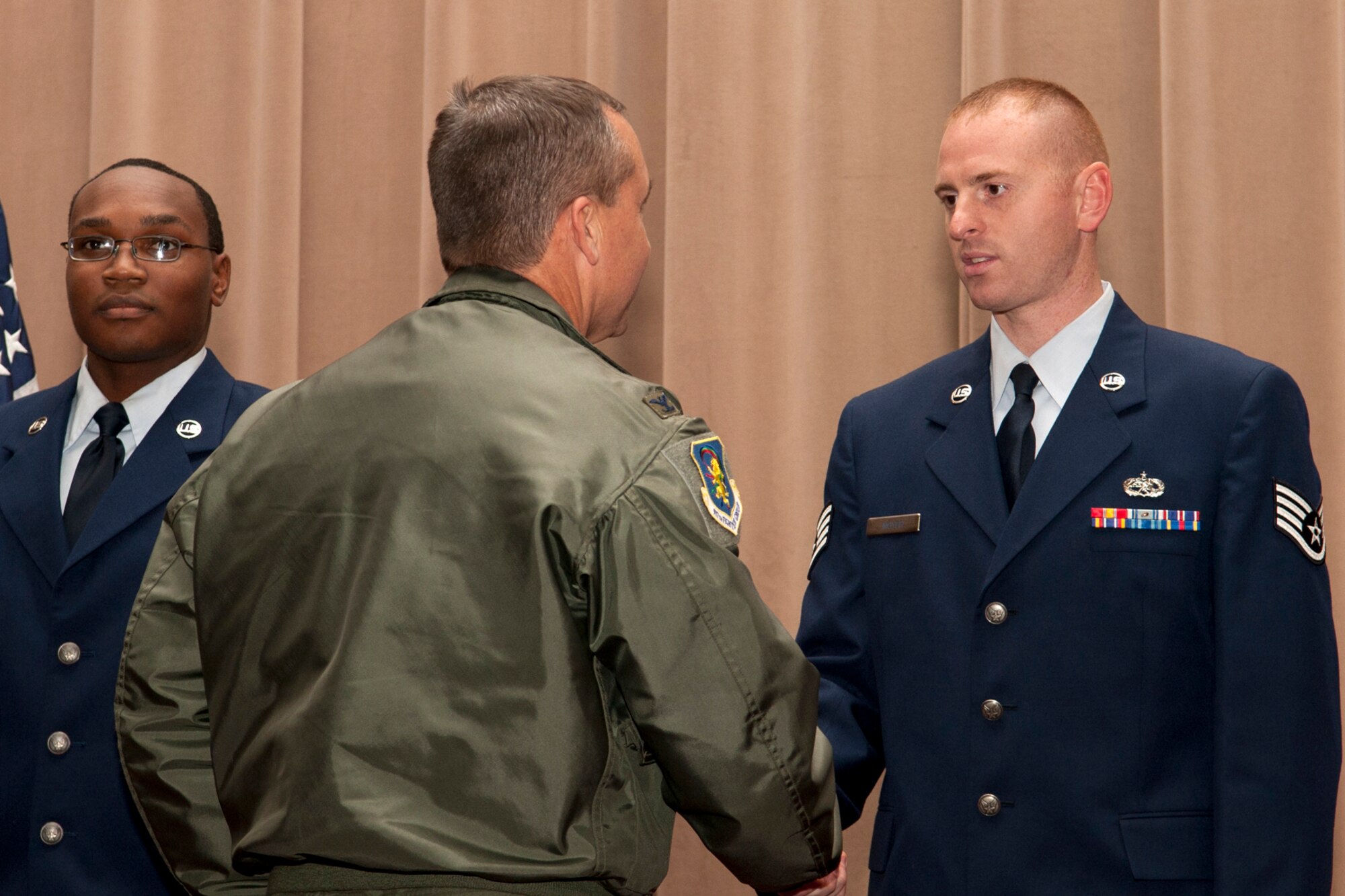 U.S. Air Force Col. John Breazeale, 917th Fighter Group commander, congratulates Staff Sgt. Russell Moyer during an awards ceremony, Barksdale Air Force Base, La., Dec. 4, 2011. Moyer, assigned to the 307th Maintenance Squadron, was recognized as the Noncommissioned Officer of the Quarter for the period covering July to September 2011. (U.S. Air Force photo by Master Sgt. Greg Steele/Released)
