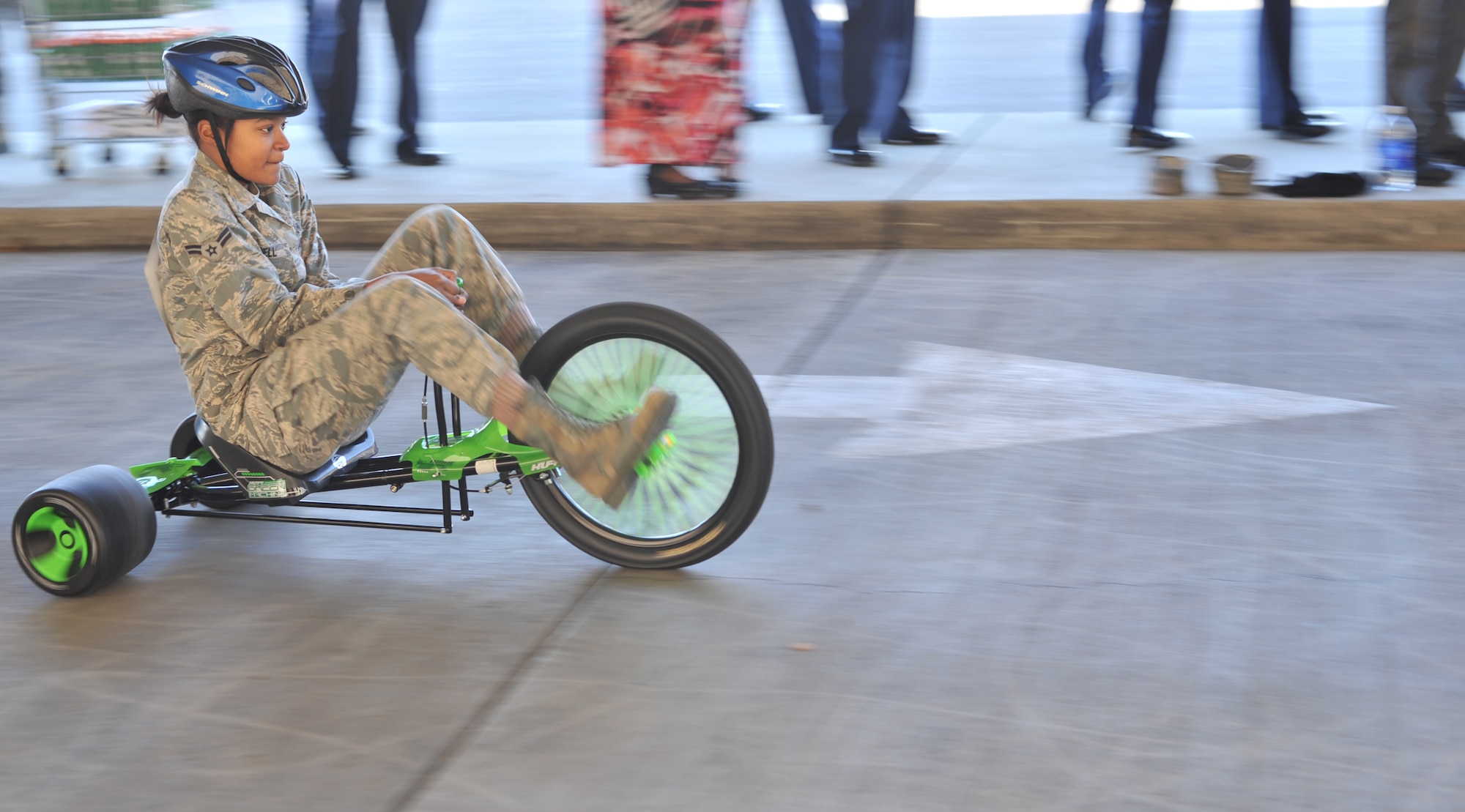 Airman 1st Class Alaine Bell, 60th Medical Group, races to the finish line to switch riders at the Travis Air Force Base Commissary Dec. 5. (U.S. Air Force/ Airman 1st Class Nicole Leidholm)