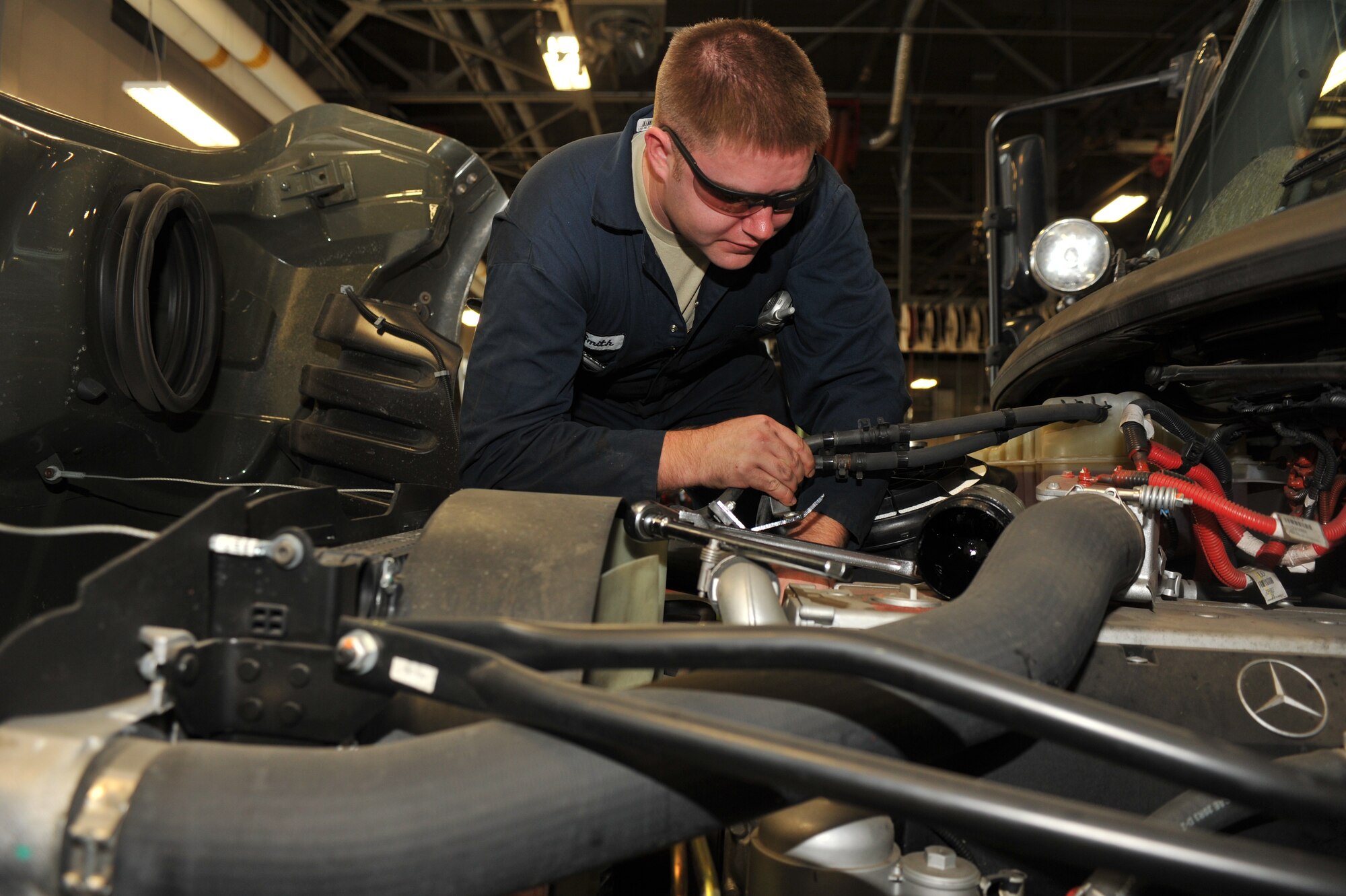Senior Airman William Smith, 92nd Logistics Readiness Squadron Multipurpose Shop mechanic, tightens a bolt on the engine of a truck Dec. 2. Smith performs vehicle maintenance activities on military and commercial general purpose vehicles and equipment. Jobs include inspection, diagnostics, repair and rebuilding of components and assemblies. (U.S. Air Force photo/Airman 1st Class Tyirez Frost)