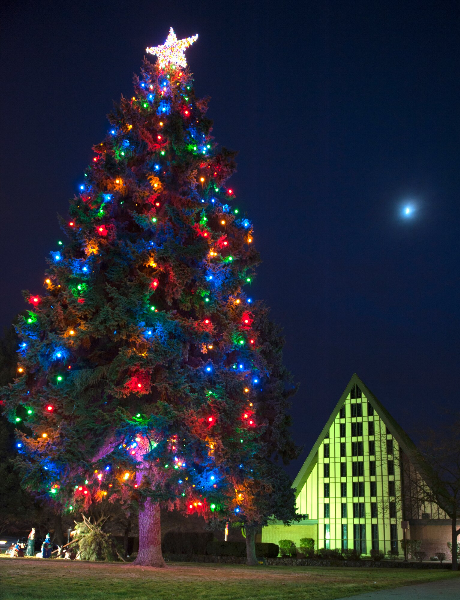Members of Team Fairchild gathered at the base chapel to witness a base tree lighting ceremony to welcome in the holiday season Dec 1. The event also included festivities with choir music, refreshments and a visit from Santa. (U.S. Air Force photo/Staff Sgt. Michael Means)