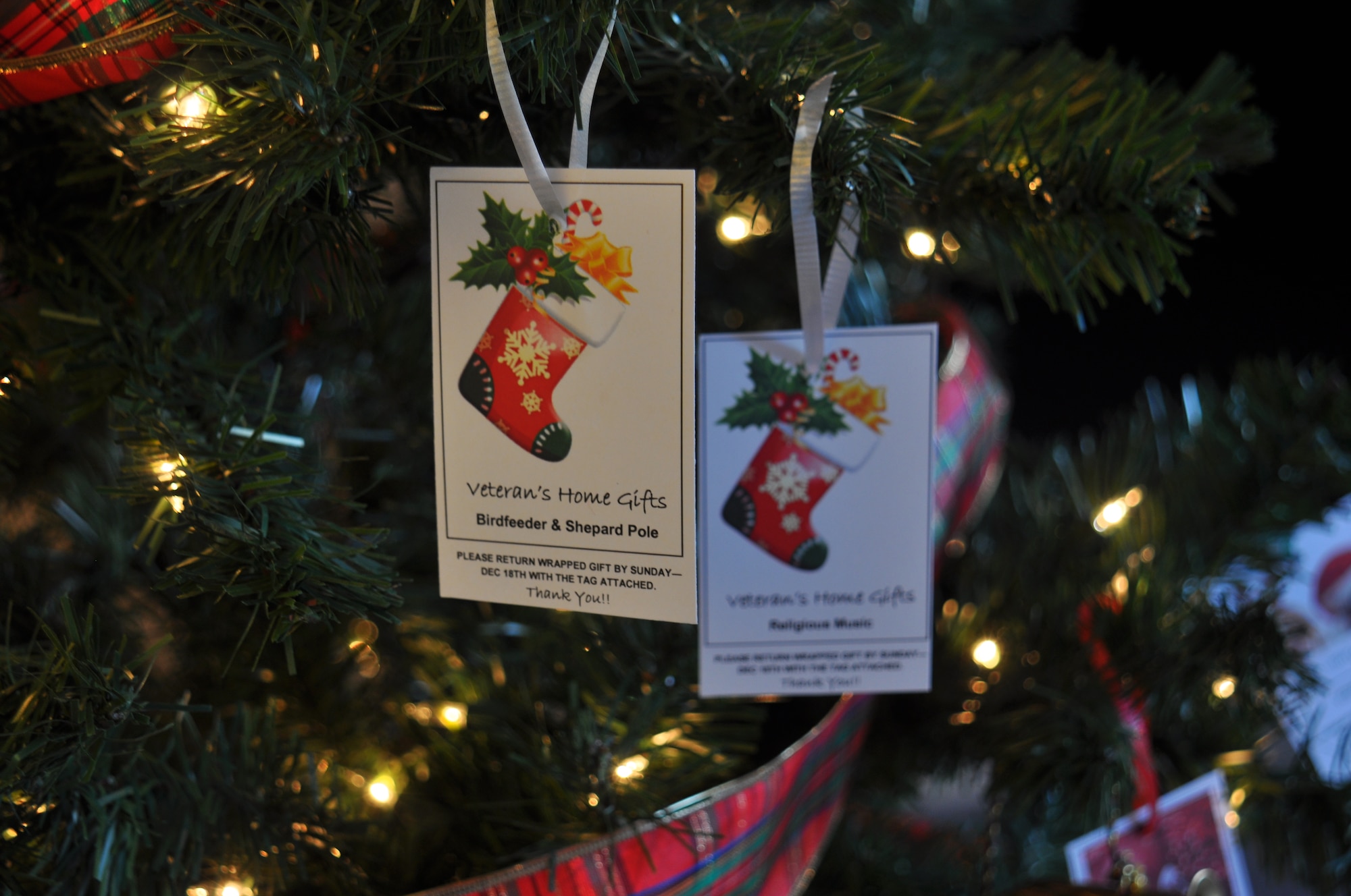 Two ornaments hang on the Giving Tree in the main lobby of the chapel. The cards have Christmas wishes [gifts] from veterans at the Spokane Veterans Home. People are encouraged to stop by the chapel and take a card then purchase a gift for the veterans. (U.S. Air Force photo/Scott King)