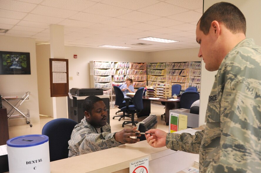 Tech Sgt. Hilliard Reese, 4th Aerospace Medicine Squadron dental technician, checks in a patient for an appointment at the dental clinic on Seymour Johnson Air Force Base, N.C., Dec. 7, 2011. Dental technicians assist the dentist during cleaning and surgeries, update medical records and check-in patients. Reese is a native of Charleston, S.C. (U.S. Air Force photo by Senior Airman Whitney Stanfield) 