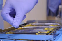 Airman 1st Class Kristopher Little, 4th Aerospace Medicine Squadron (AMDS) dental technician, reaches for a hand instrument in a cavity operative kit before conducting  a refill cavity procedure on Seymour Johnson Air Force Base, N.C., Dec. 7, 2011.  The cavity operative kit includes dental instruments designed to get in tight areas. Cavities and extractions are the most common dental procedure. Little is from Charleston, S.C. (U.S. Air Force photo by Senior Airman Whitney Stanfield)