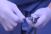 Airman 1st Class Kristopher Little, 4th Aerospace Medicine Squadron dental technician, adds an air and water tip to a syringe before a refill cavity procedure on Seymour Johnson Air Force Base, N.C., Dec. 7, 2011.  New syringe tips are used for each patient to prevent spreading germs. There are more than 600 oral bacterium in a human mouth. Little is from Charleston, S.C. (U.S. Air Force photo by Senior Airman Whitney Stanfield)
