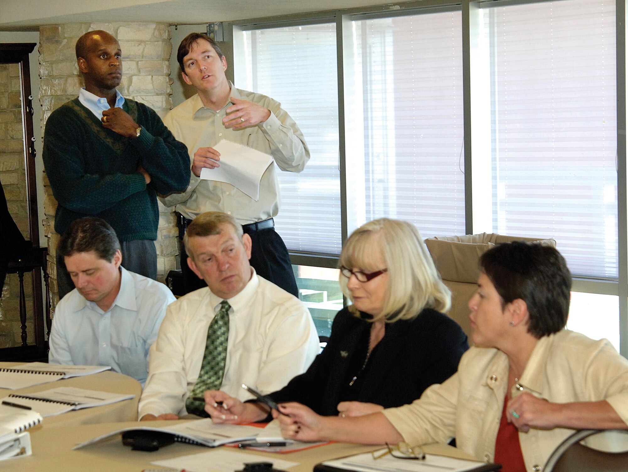 Approximately 46 leaders of the 76th Maintenance Wing put their heads together Nov. 29-30 during an off-site to hone a five-year plan focused on making the wing’s output even better for the warfighters.  Col. Cedric George, 76th MXW commander standing left, and deputy director Kevin O’Connor review ideas on a screen at the front of the room while a breakout team plans. Seated from left are Steve Stoner, 547th Propulsion Maintenance Squadron director; Mike Mowles, 551st Commodities Maintenance Squadron director; Debi Kirkpatrick 76th MXW Business Operations deputy chief; and Theresa Farris, 564th Aircraft Maintenance Squadron director. (Air Force photo by Margo Wright)
