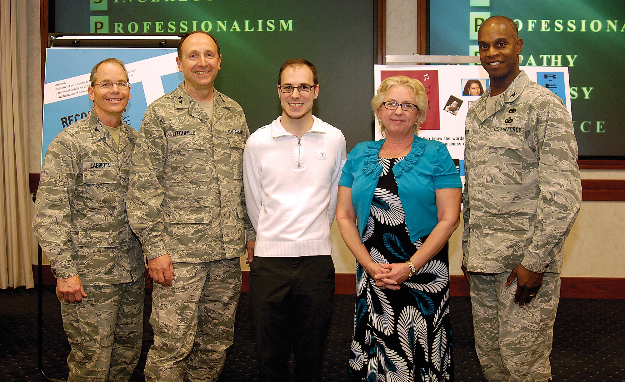 R.E.S.P.E.C.T.
“R.E.S.P.E.C.T. isn’t just a program, a flash in the pan, but it’s a way of living,” emphasized Oklahoma City Air Logistics Center Commander Maj. Gen. Bruce Litchfield, second from left, during a Dec. 1 award ceremony recognizing two Tinker employees whose respect-themed posters were chosen as winners to promote the R.E.S.P.E.C.T program. Winners Joe Levine, 72nd Communications Squadron, and Starlyn Cooper, 76th Maintenance Wing, created their posters around the acronym R.E.S.P.E.C.T. Promoting Recognition, Equality, Sincerity, Professionalism, Empathy, Courtesy and Tolerance as part of the center’s culture is the program’s goal. “Respect should be ingrained in everything we do every day,” said Col. Bob LaBrutta, left, the 72nd Air Base Wing and installation commander. “It’s the little things we do daily. It’s not hard,” said Col. Cedric George, 76th MXW commander, right. “If we do it as a team, people can come to work and unleash their maximum potential, doing great work,” he said. (Air Force photo by Margo Wright)
