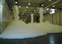 Torrents of foam flow from ceiling nozzles during a test of an aircraft hangar’s fire suppression system at Duke Field, Fla., recently. The test, conducted by contractor Barlovento, LLC and the U.S. Army Corps of Engineers, was required for final certification of the newly refurbished hangar prior to its official reopening. (U.S. Air Force photo/Dan Neely)
