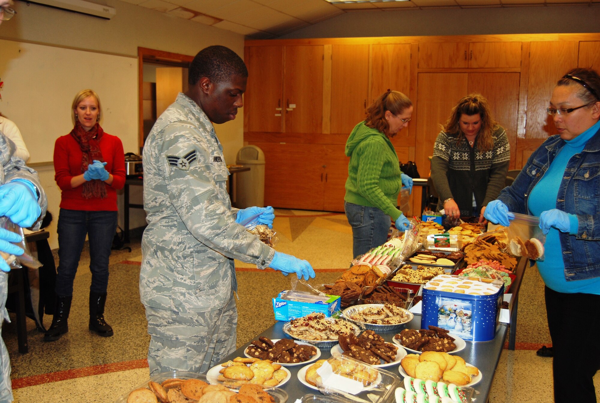 Volunteers from Peterson Air Force Base and the Peterson Spouses’ Club gathered Nov. 6 after work to fill bags of cookies for the 450 Airmen living in the dorms. The spouses’ club collected hundreds of dozens of cookies from volunteers over two days. (U.S. Air Force photo/Lea Johnson)