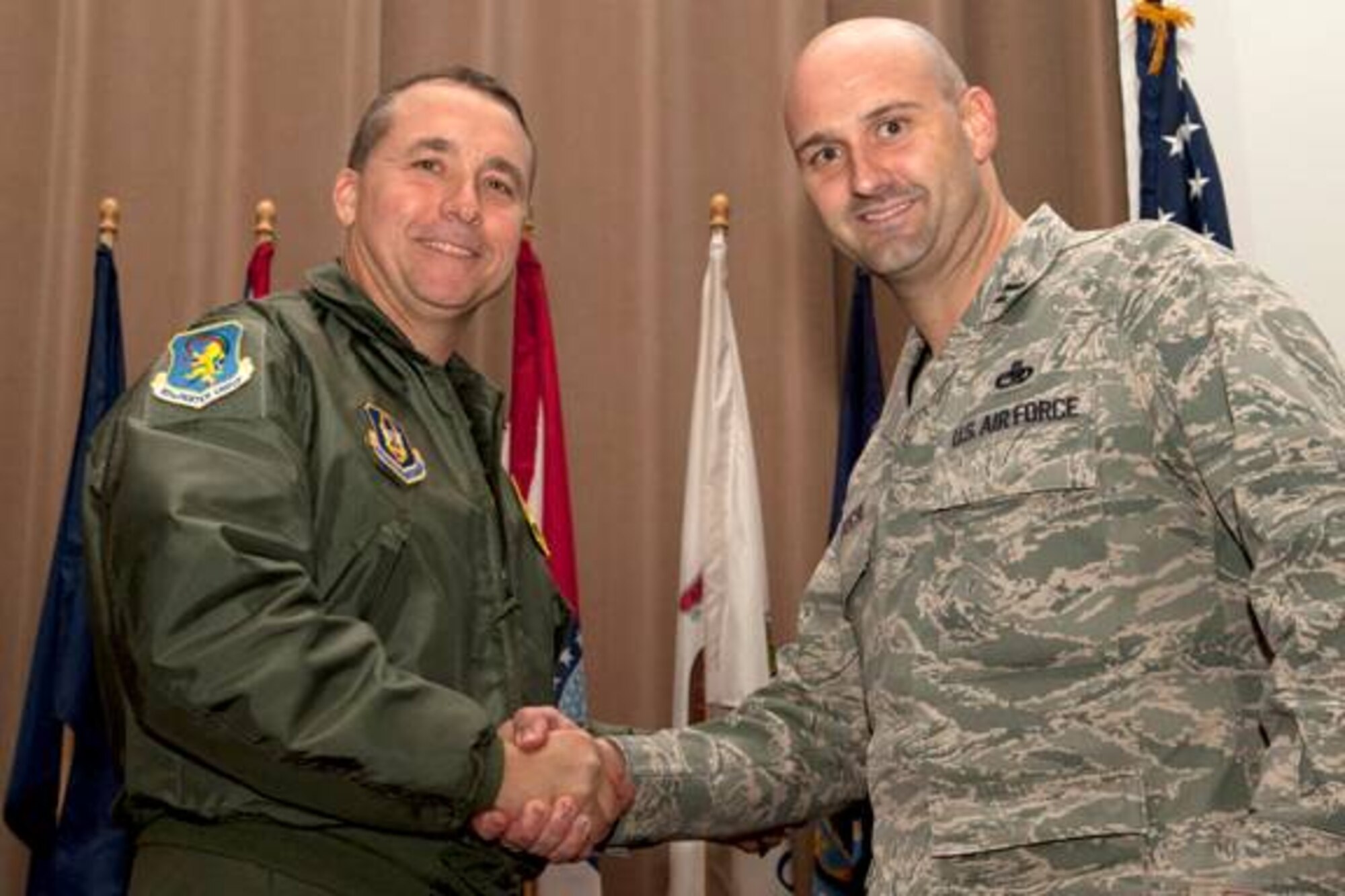 U.S. Air Force Col. John Breazeale, 917th Fighter Group commander, recognizes U.S. Air Force Maj. Grant McCall during a commander's call ceremony, Barksdale Air Force Base, La., Nov, 4, 2011. McCall, an A-10 pilot assigned to the 47th Fighter Squadron, was recognized as the Field Grade Office of the Quarter. (U.S. Air Force photo by Master Sgt. Greg Steele/Released)
