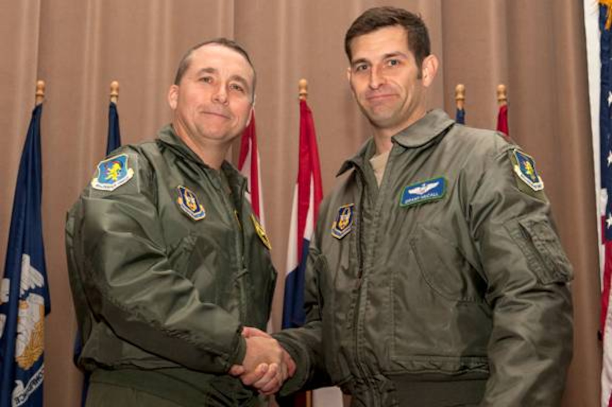 U.S. Air Force Col. John Breazeale, 917th Fighter Group commander, recognizes U.S. Air Force Capt. Brian Plauche during a commander's call ceremony, Barksdale Air Force Base, La., Nov, 4, 2011. Plauche, 917th Aircraft Maintenance Squadron maintenance officer, was recognized as the Company Grade Office of the Quarter, Sept. 2011. (U.S. Air Force photo by Master Sgt. Greg Steele/Released)