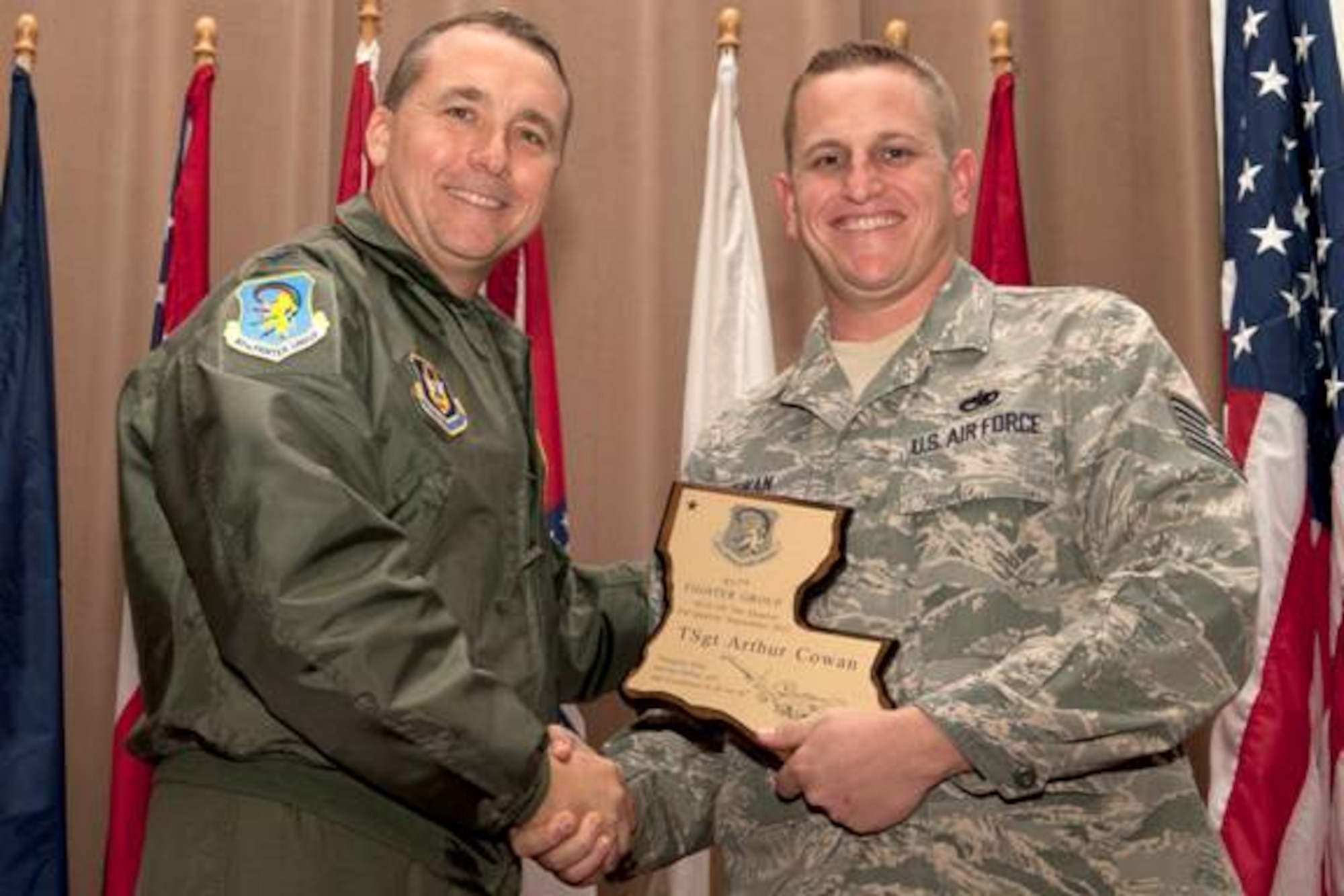 U.S. Air Force Col. John Breazeale, 917th Fighter Group commander, presents U.S. Air Force Tech. Sgt. Arthur Cowan with the 917th FG Noncommissioned Officer of the Quarter award, Barksdale Air Force Base, La., Nov, 4, 2011. Cowan, who is assigned to the 917th Aircraft Maintenance Squadron, received the award for the 3nd quarter, Sept. 2011. (U.S. Air Force photo by Master Sgt. Greg Steele/Released)