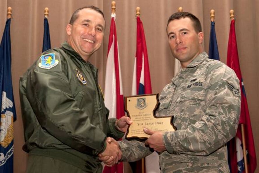 U.S. Air Force Col. John Breazeale, 917th Fighter Group commander, presents U.S. Air Force Senior Airman Lance Duay with the 917th FG Airman of the Quarter award, Barksdale Air Force Base, La., Nov, 4, 2011. Duay, who is assigned to the 917th Maintenance Squadron, received the award for the 3rd quarter, Sept. 2011. (U.S. Air Force photo by Master Sgt. Greg Steele/Released)