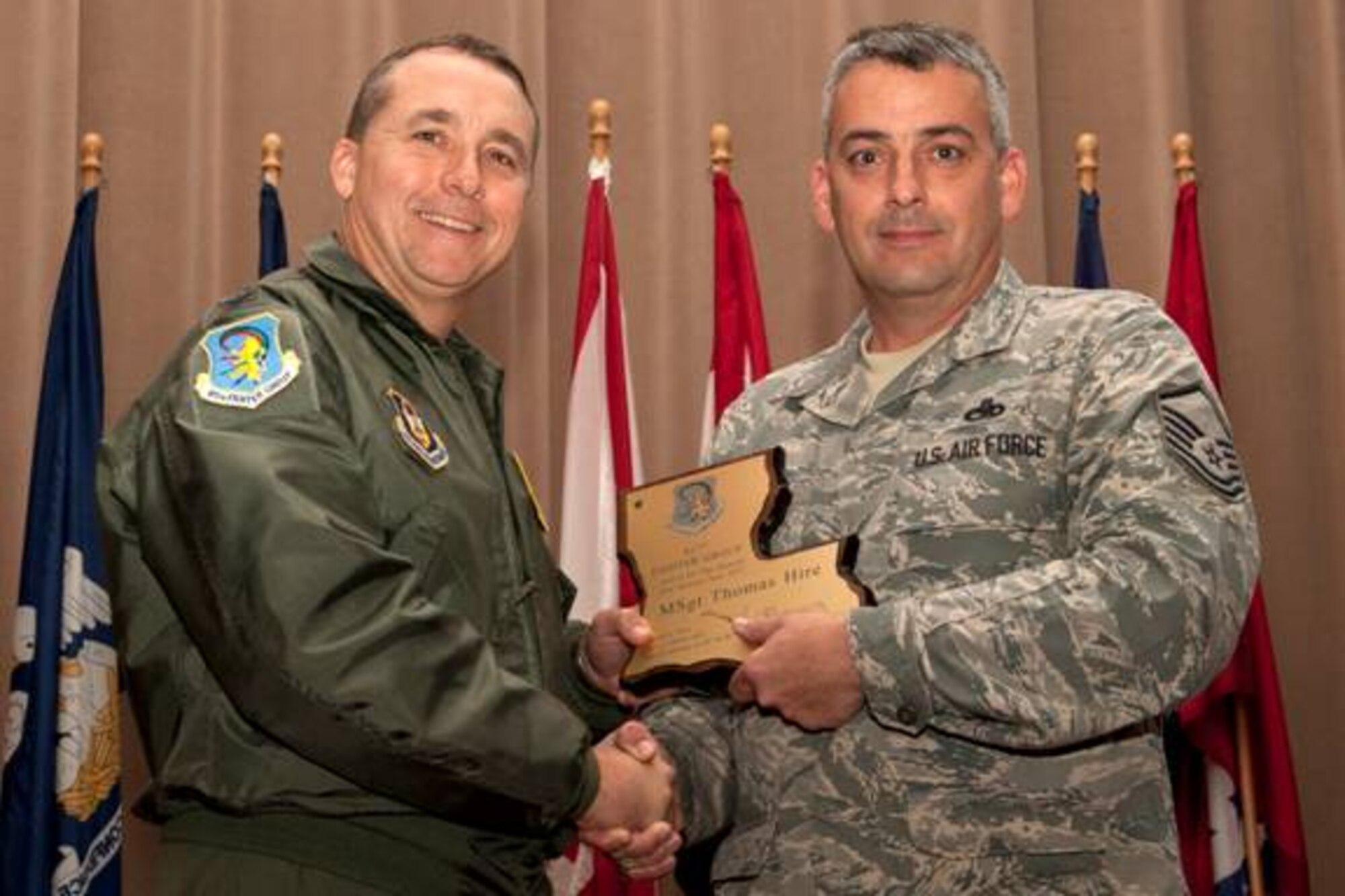 U.S. Air Force Col. John Breazeale, 917th Fighter Group commander, presents U.S. Air Force Master Sgt. Thomas Hire with the 917th FG Senior Noncommissioned Officer of the Quarter award, Barksdale Air Force Base, La., Nov, 4, 2011. Hire, who is assigned to the 917th Maintenance Operations Flight, received the award for the 2nd quarter, June 2011. (U.S. Air Force photo by Master Sgt. Greg Steele/Released)